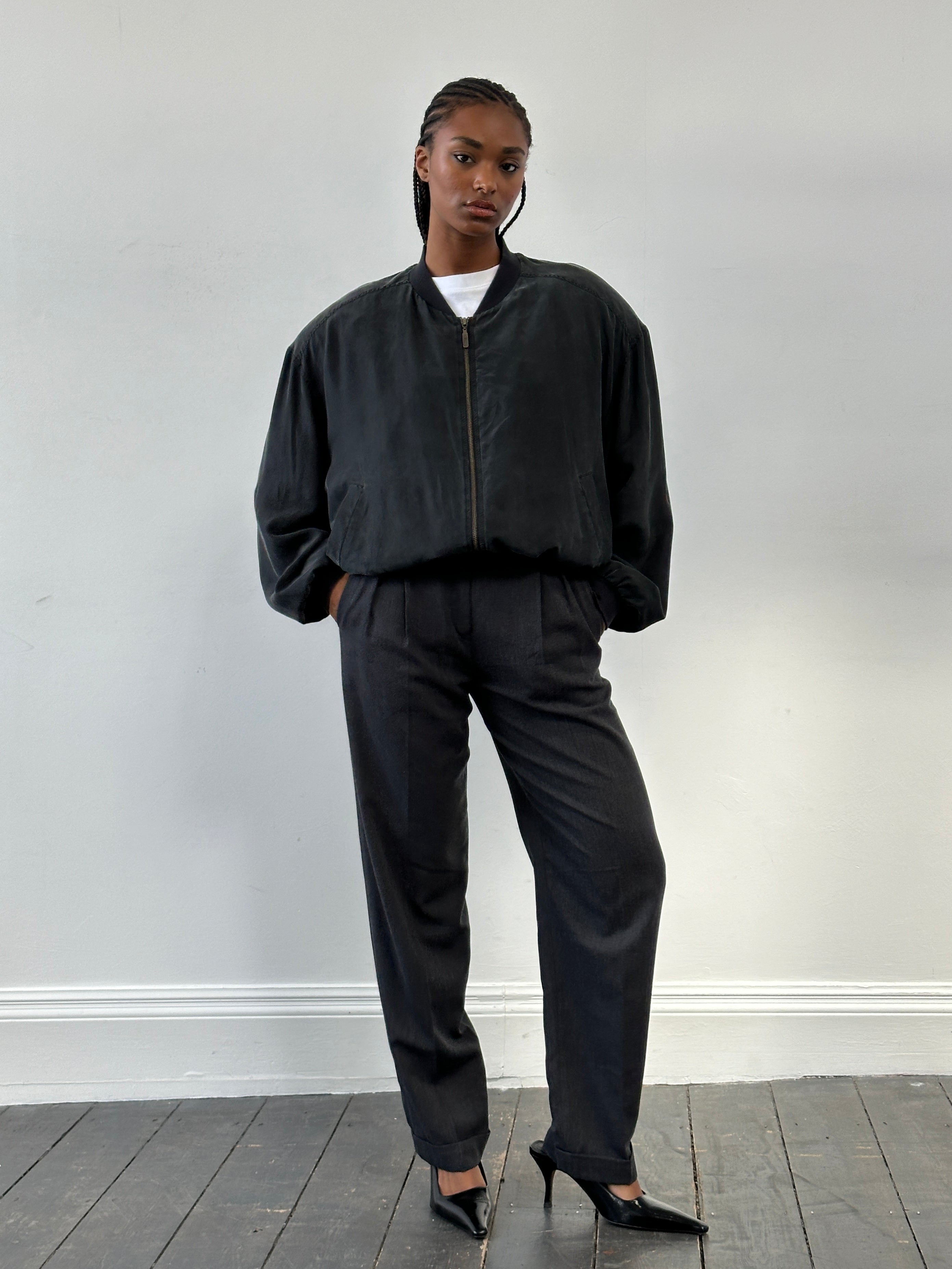 Vintage 1990s pure silk bomber jacket in size large, featuring a classic design with a sleek, shiny finish and ribbed cuffs.