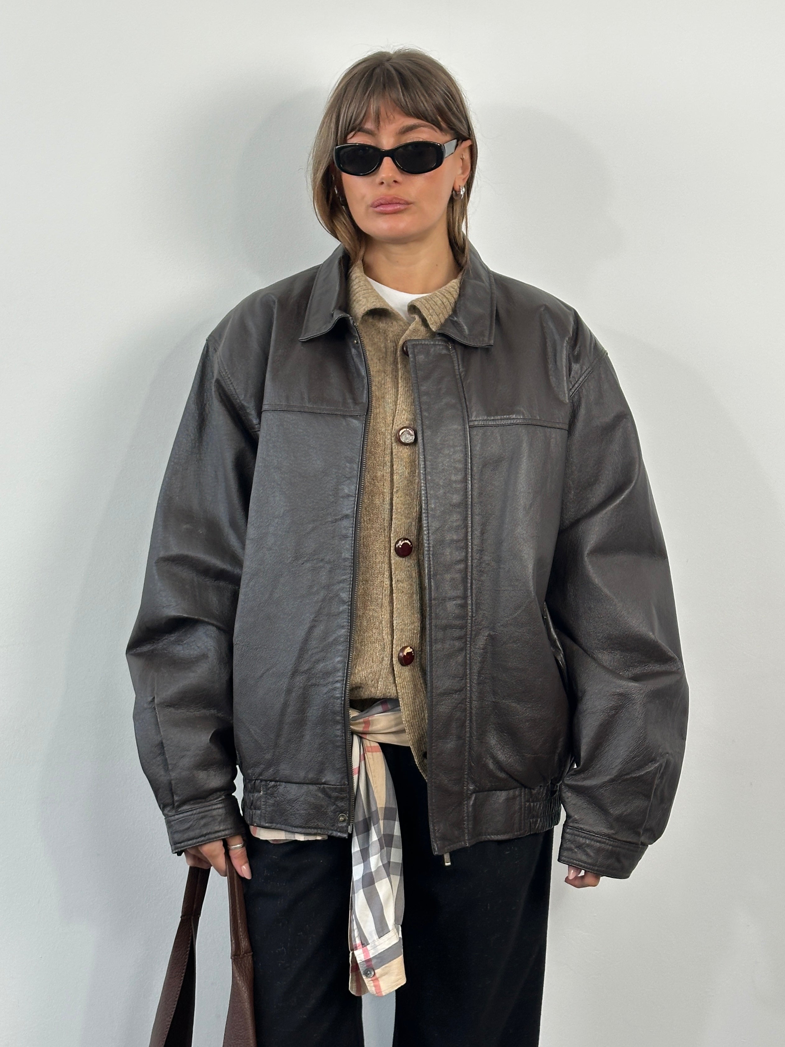 Vintage 1990s leather bomber jacket with concealed placket, in XL/XXL size, featuring classic design and distressed leather finish.