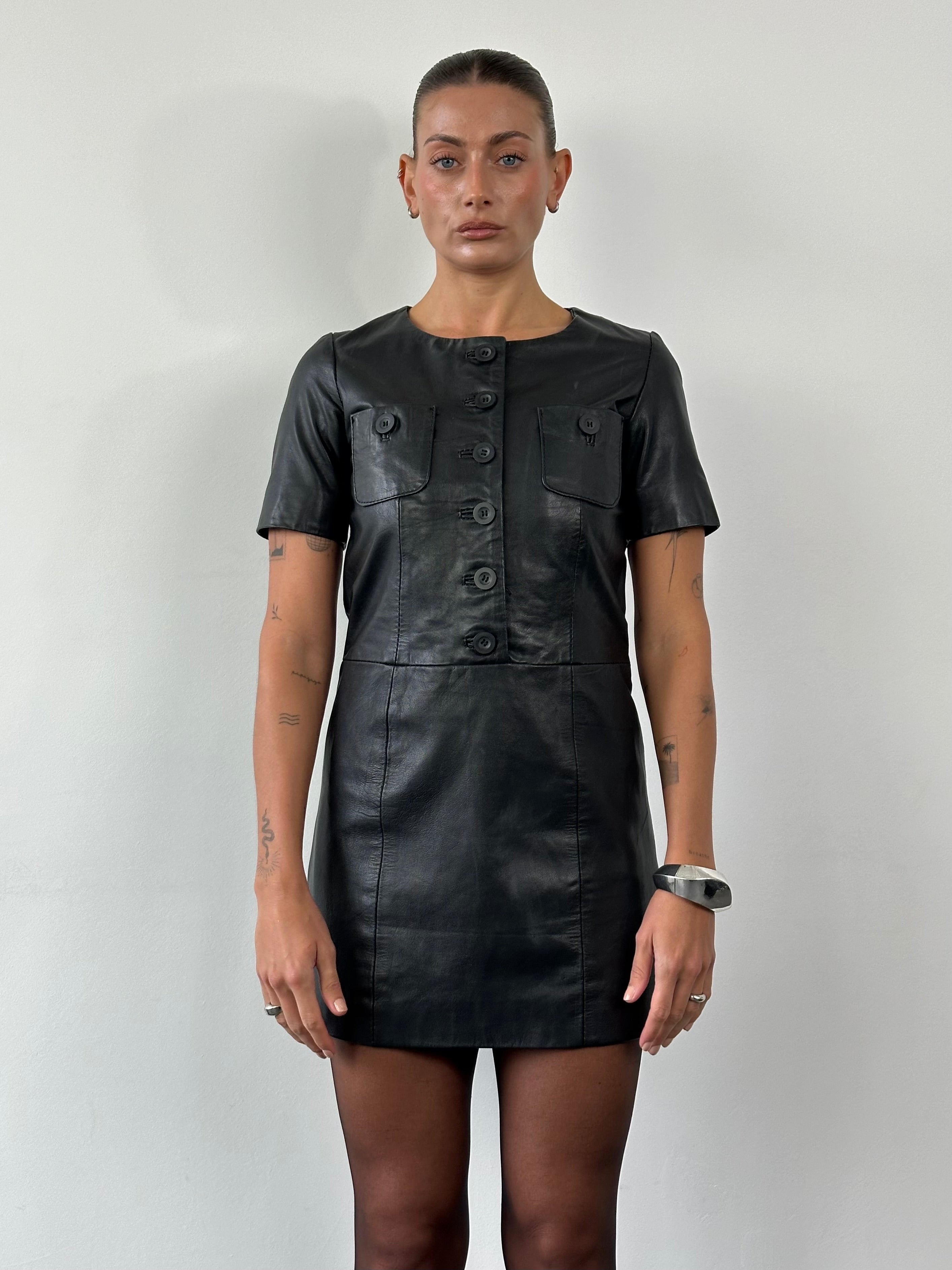 Vintage leather mini dress in size S featuring a classic cut and textured material, perfect for stylish casual or evening wear.