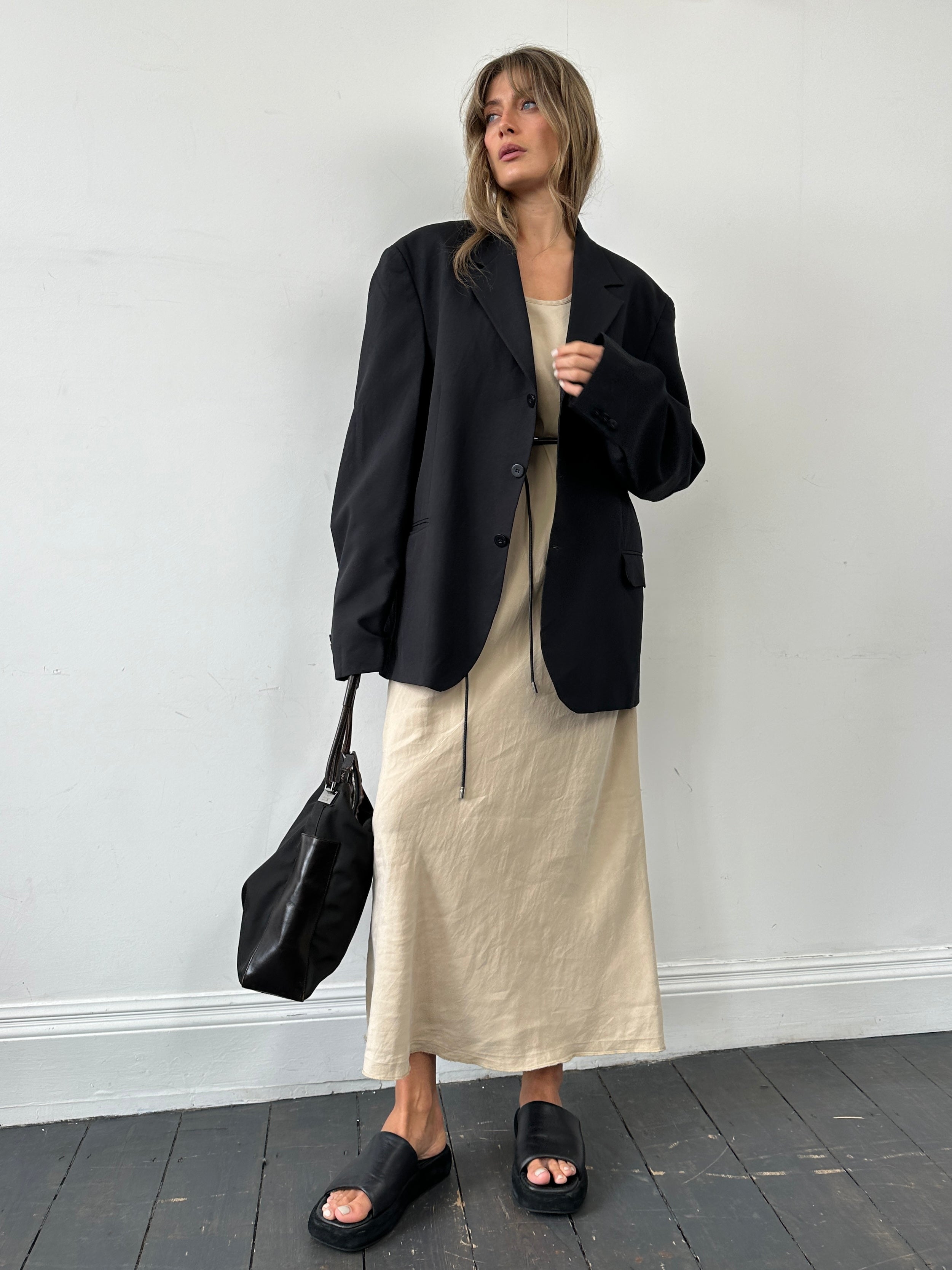 Jaeger silk linen floor length dress in S/M displayed on a hanger, showcasing its elegant flowing design and neutral color.