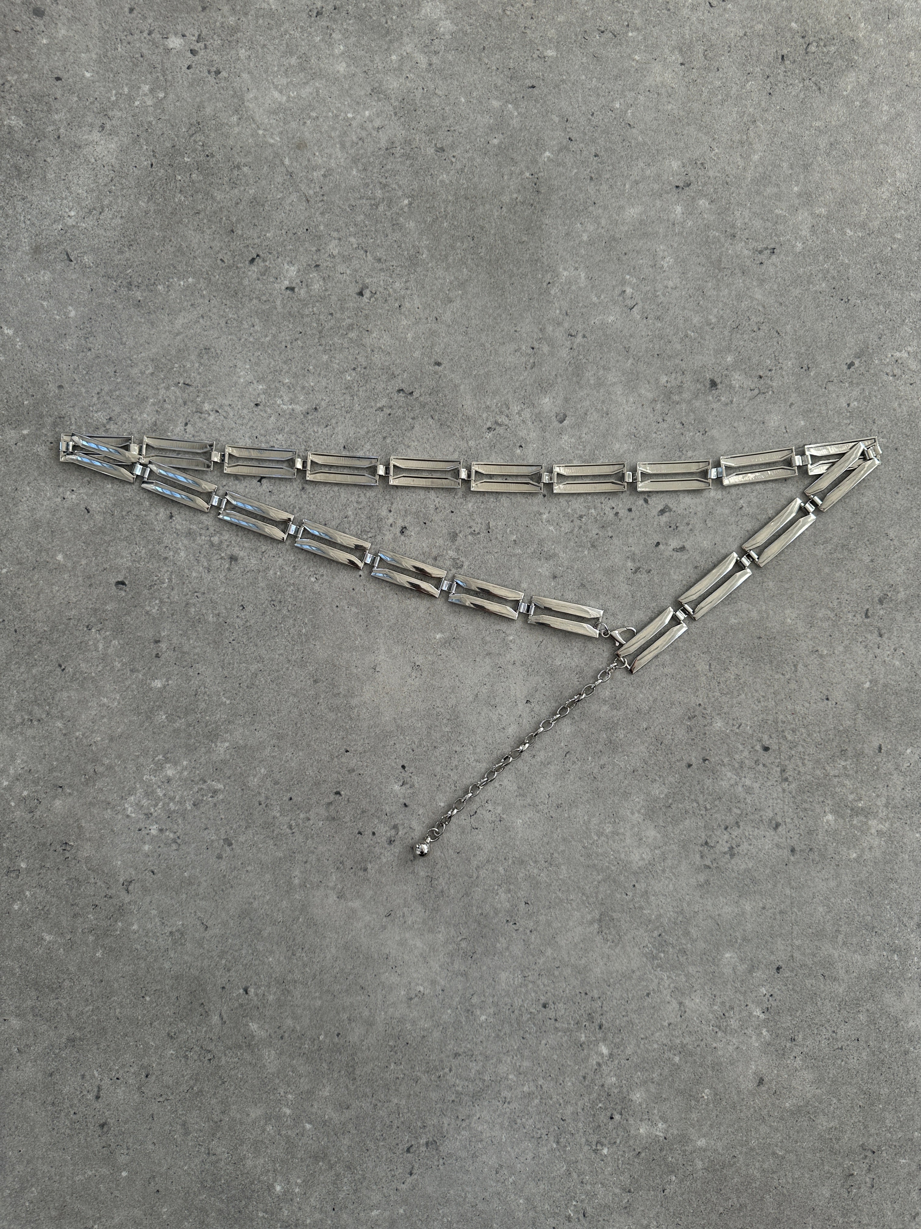 Vintage 2000s metal chain belt showcasing a bold, industrial style with linked metal chains on a neutral background.