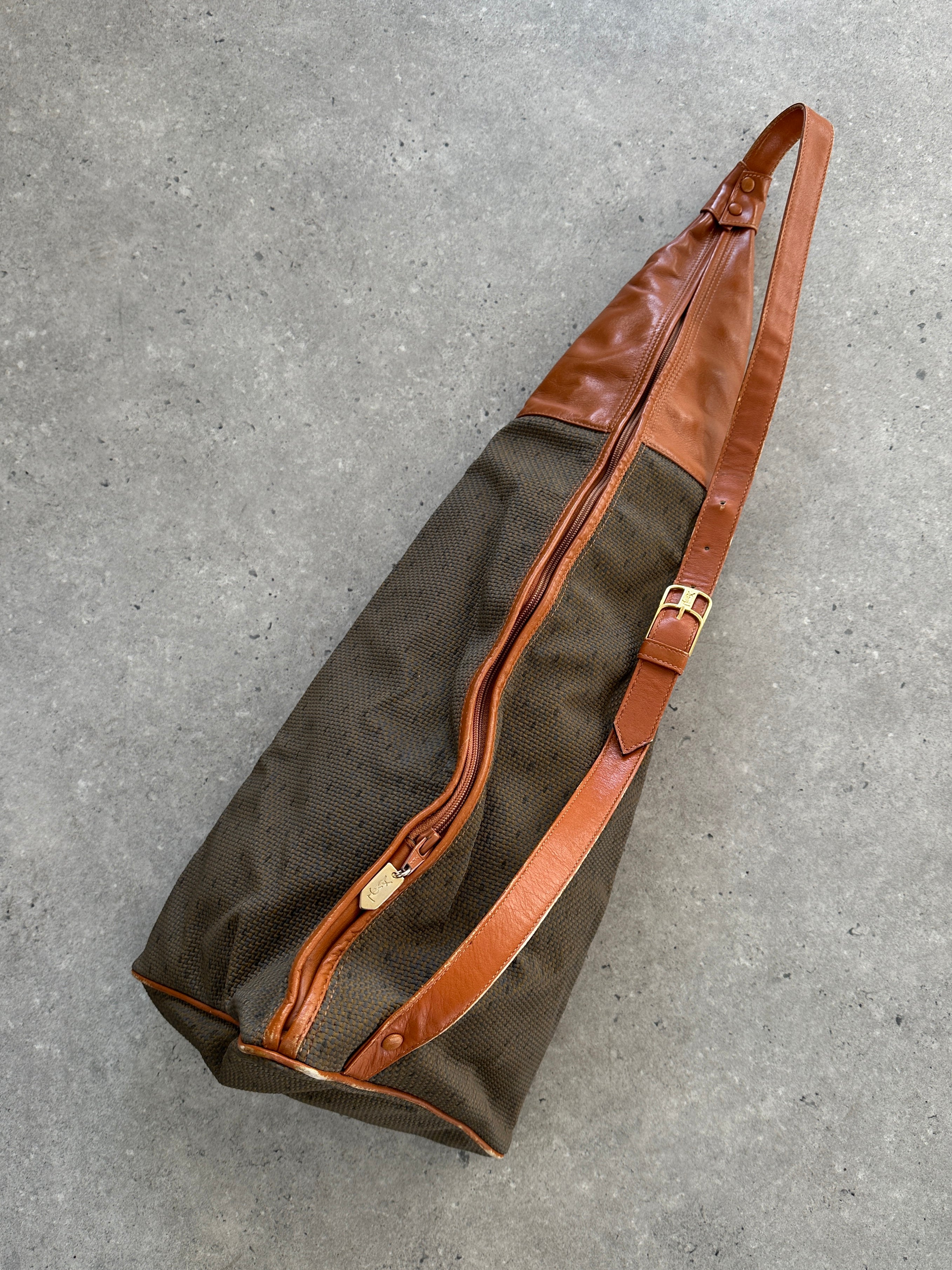 Yves Saint Laurent Paris 80s leather sling bag with adjustable strap and classic design, featuring black textured leather.