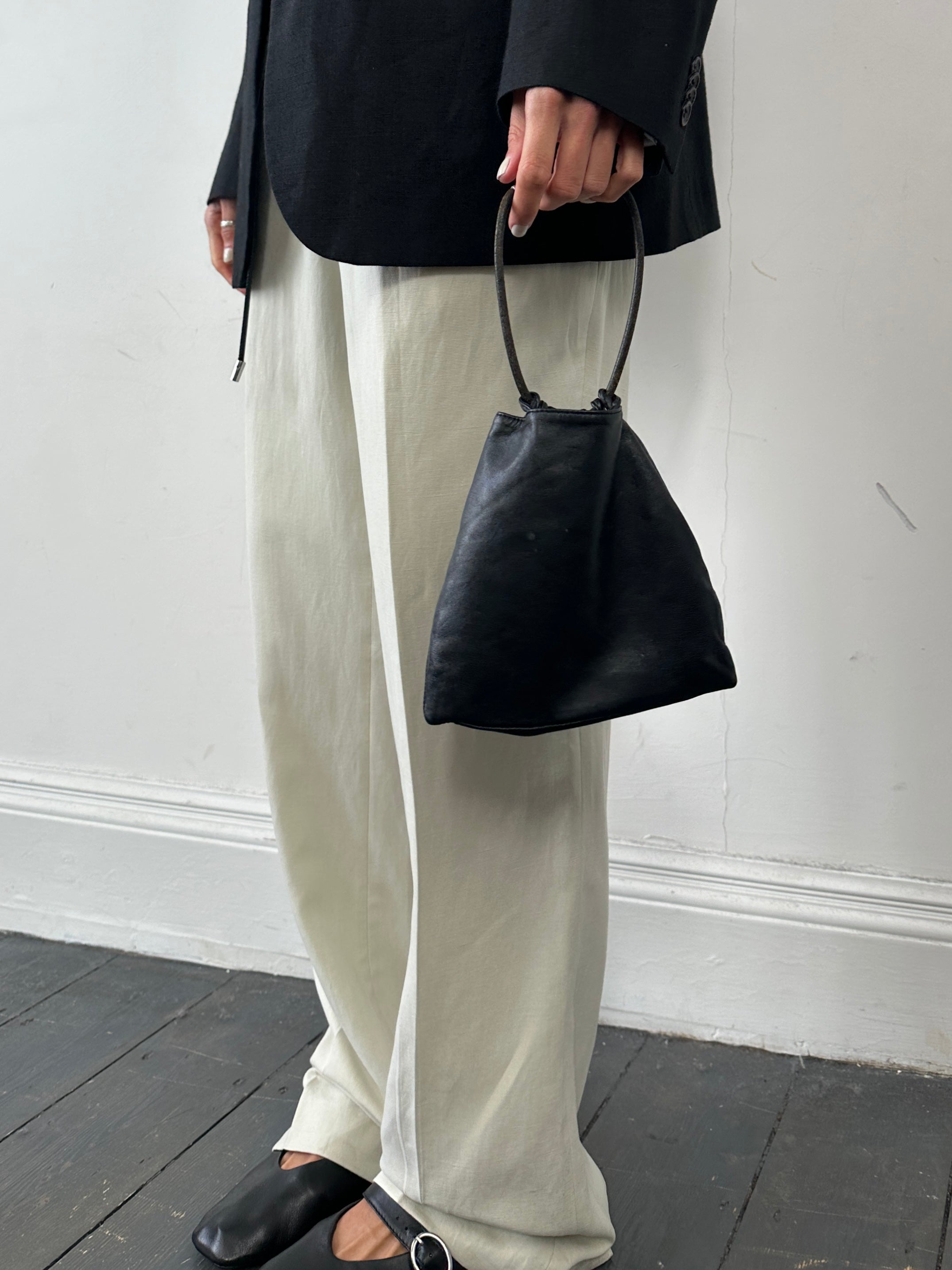 DKNY soft leather clutch bag with sleek design and minimal details, perfect for elegant evening or daytime use.