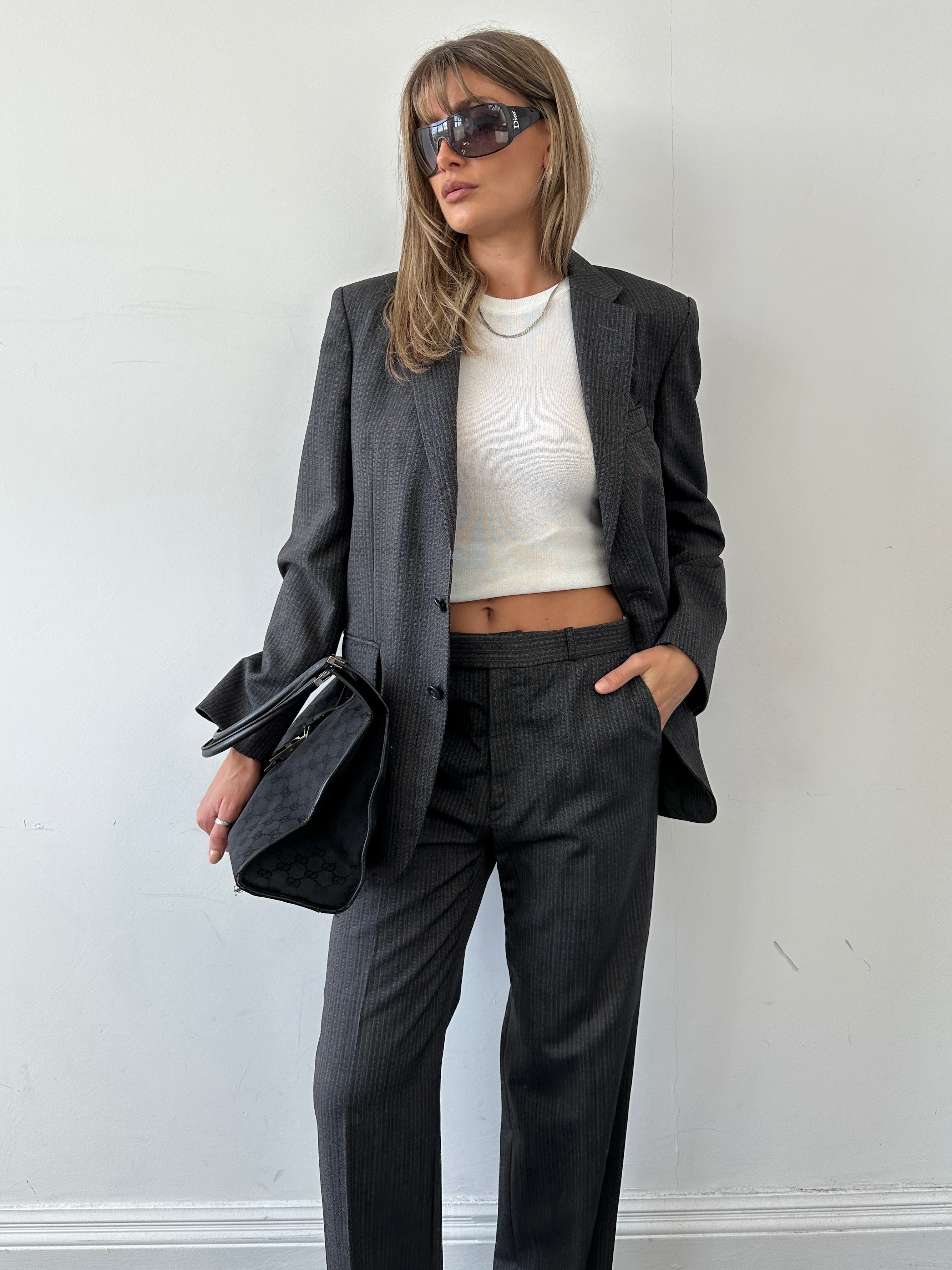 Christian Dior pinstripe single-breasted pure wool jumpsuit in size 40R/W32, featuring tailored lapels and a fitted silhouette.