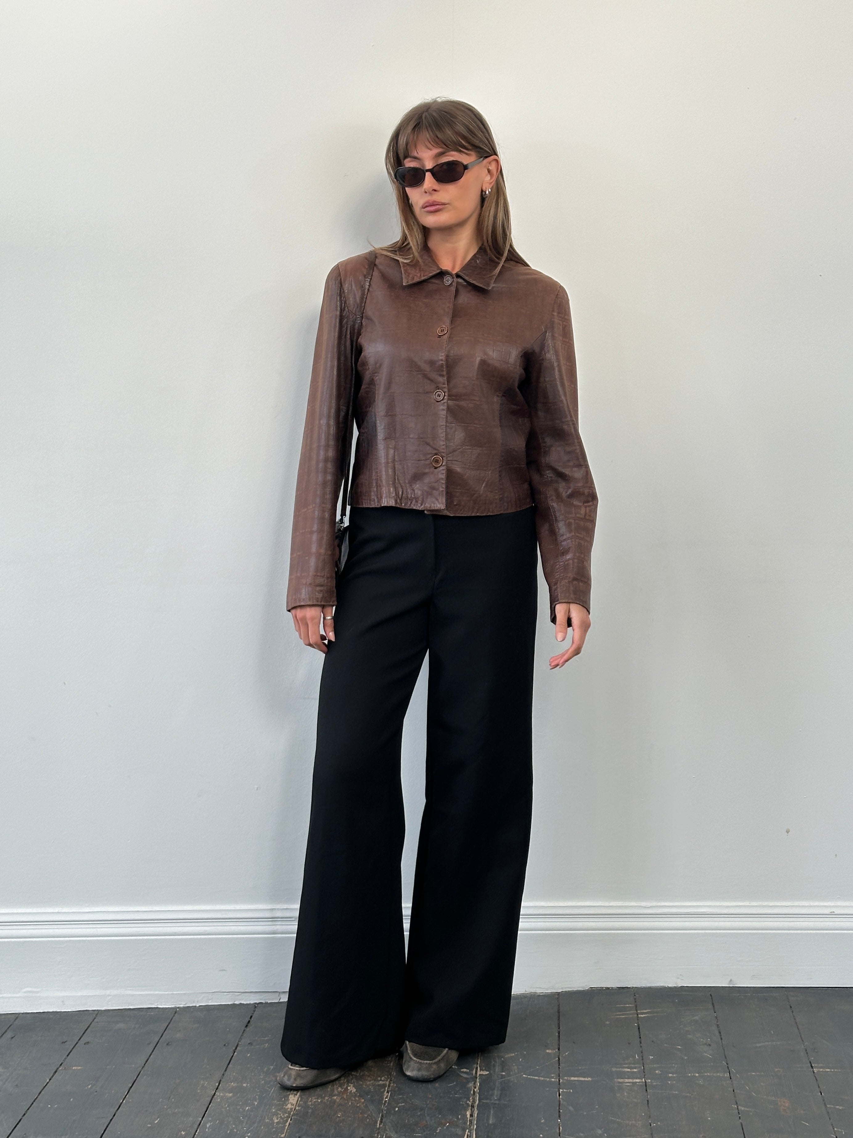 Vintage 1990s pure wool wide-leg tailored trousers in size W26, featuring a classic fit and textured fabric.
