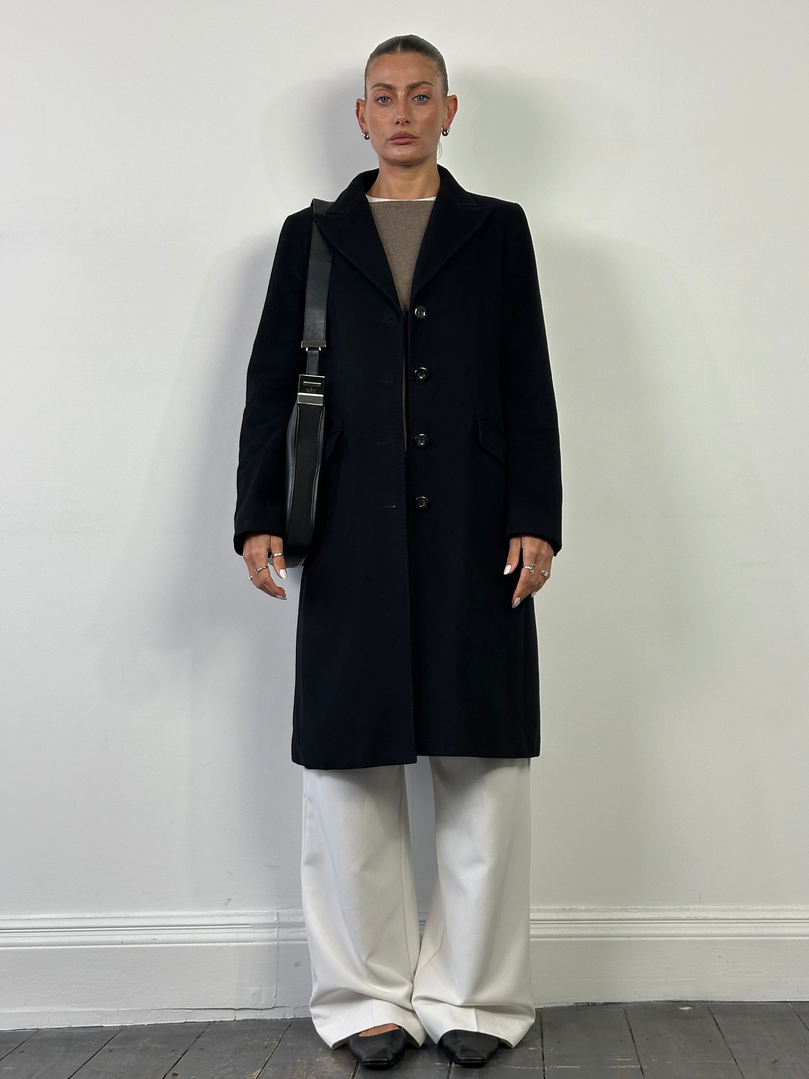 Max Mara Studio pure virgin wool single-breasted coat in black, displayed on a hanger, with a classic lapel and tailored fit.