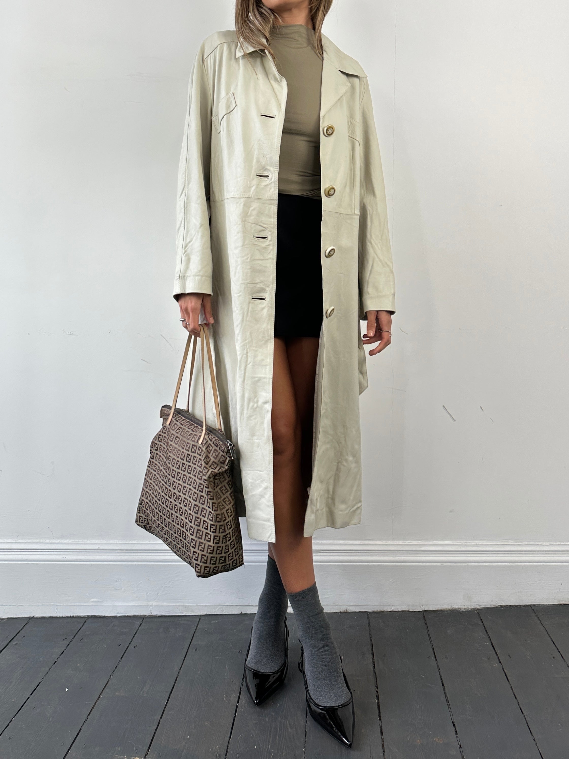 Vintage belted leather trench coat jacket in size M, featuring classic design, shoulder epaulets, and a waist belt.