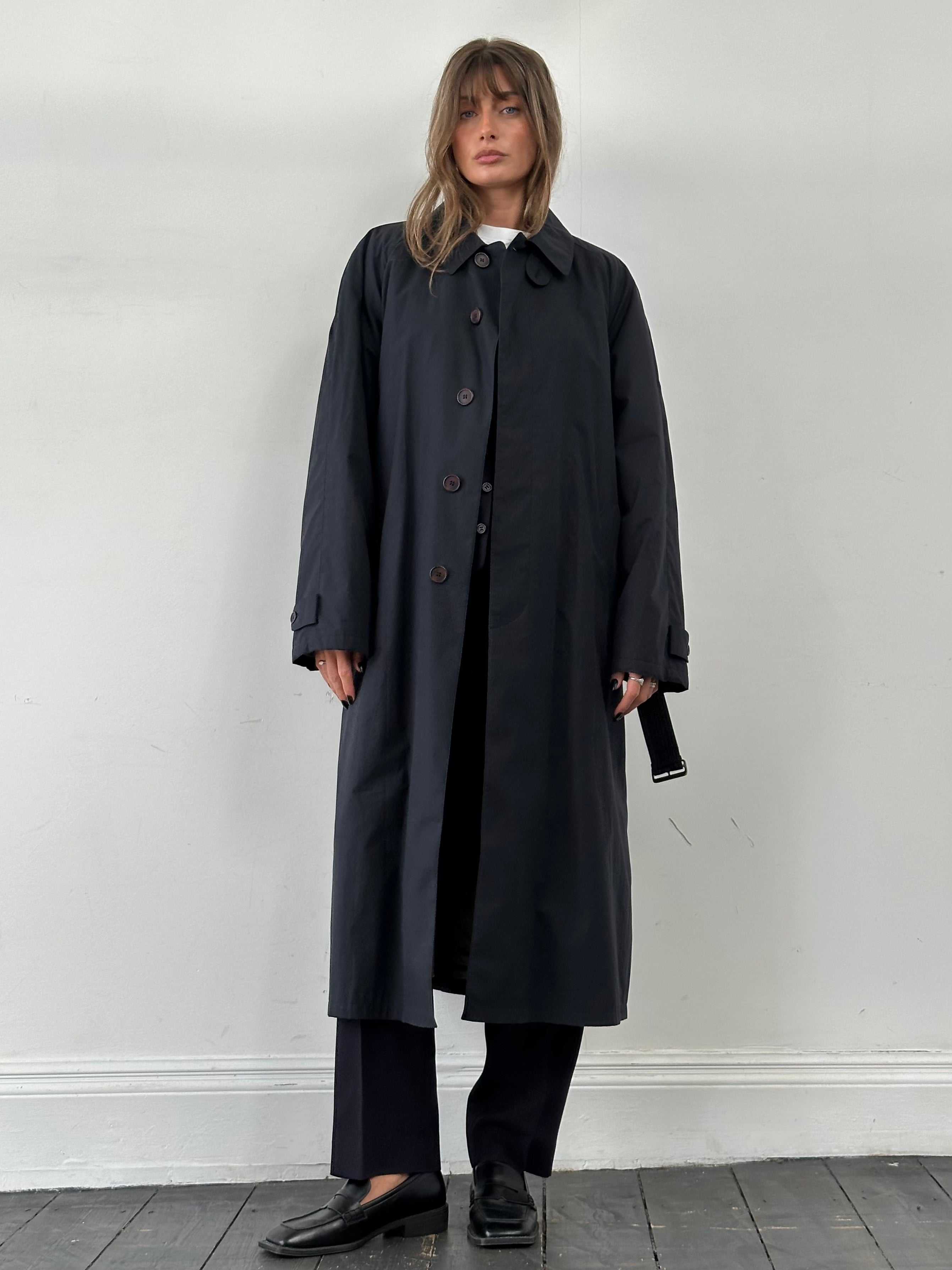 Giorgio Armani Le Collezioni cotton belted trench coat in XL, displayed hanging with a classic beige design and button details.
