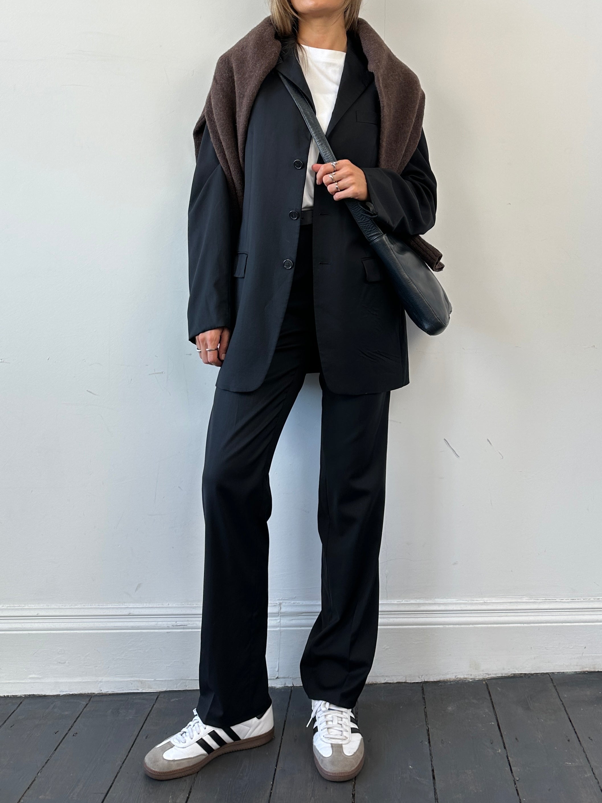 Prada virgin wool jumpsuit, mid-rise, single-breasted design, in a tailored fit, displayed in a neutral setting.