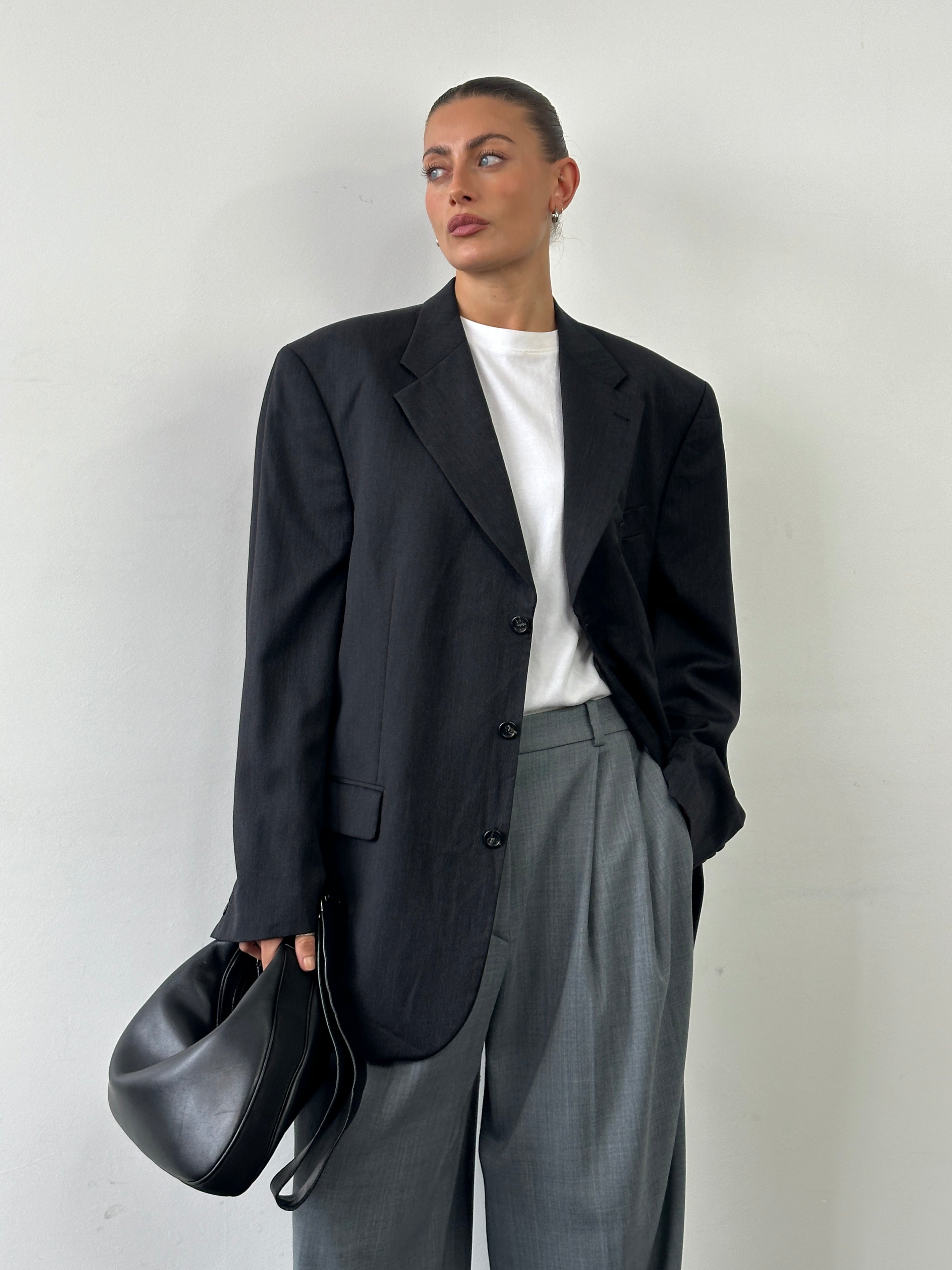 Yves Saint Laurent Pour Homme 1990s pure wool single-breasted blazer in size 48R/XXL, shown on a hanger with classic tailoring details.