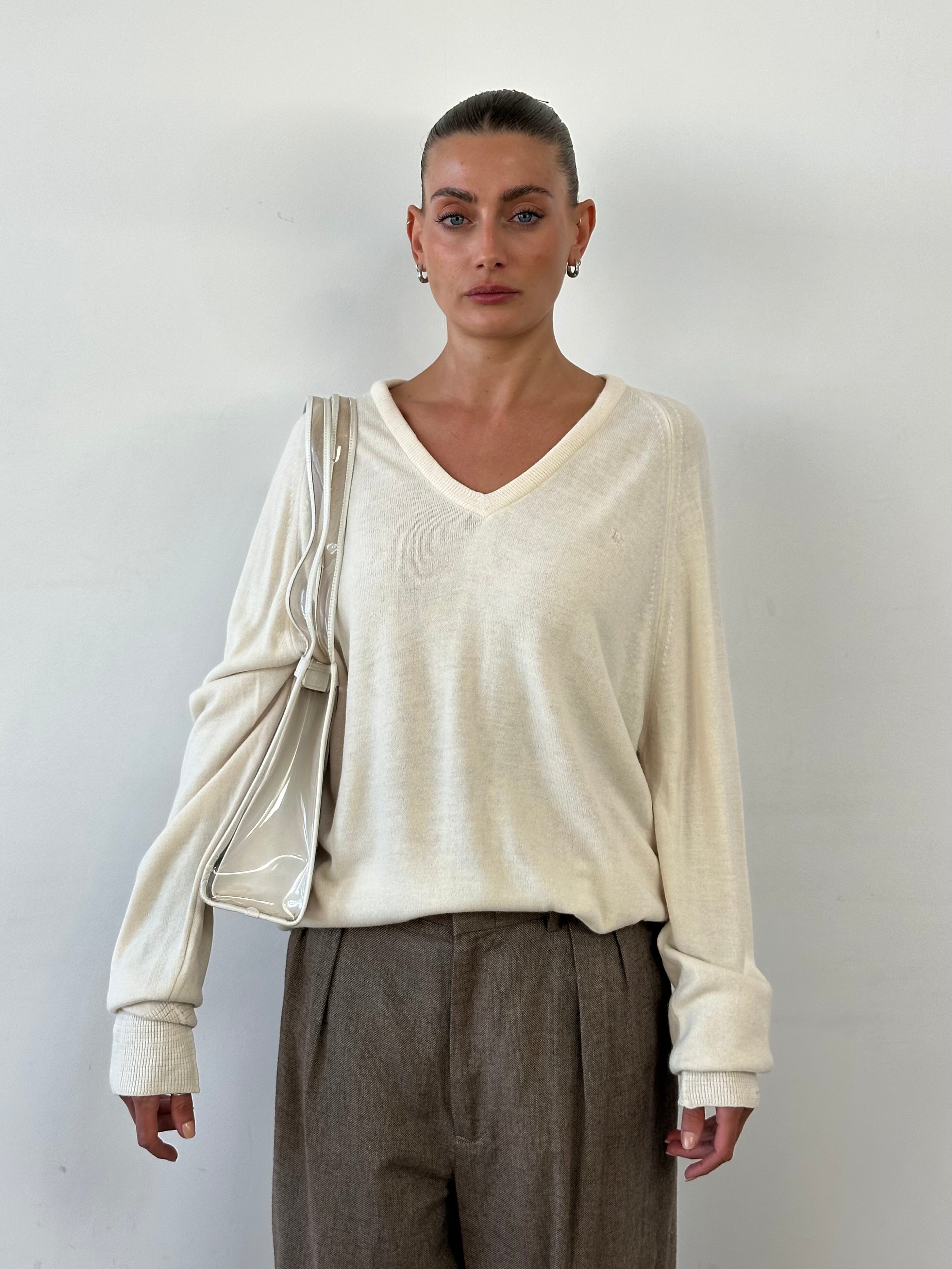 Christian Dior V neck logo knitted jumper in XL, showing the soft knit fabric and subtle Dior branding on the chest.