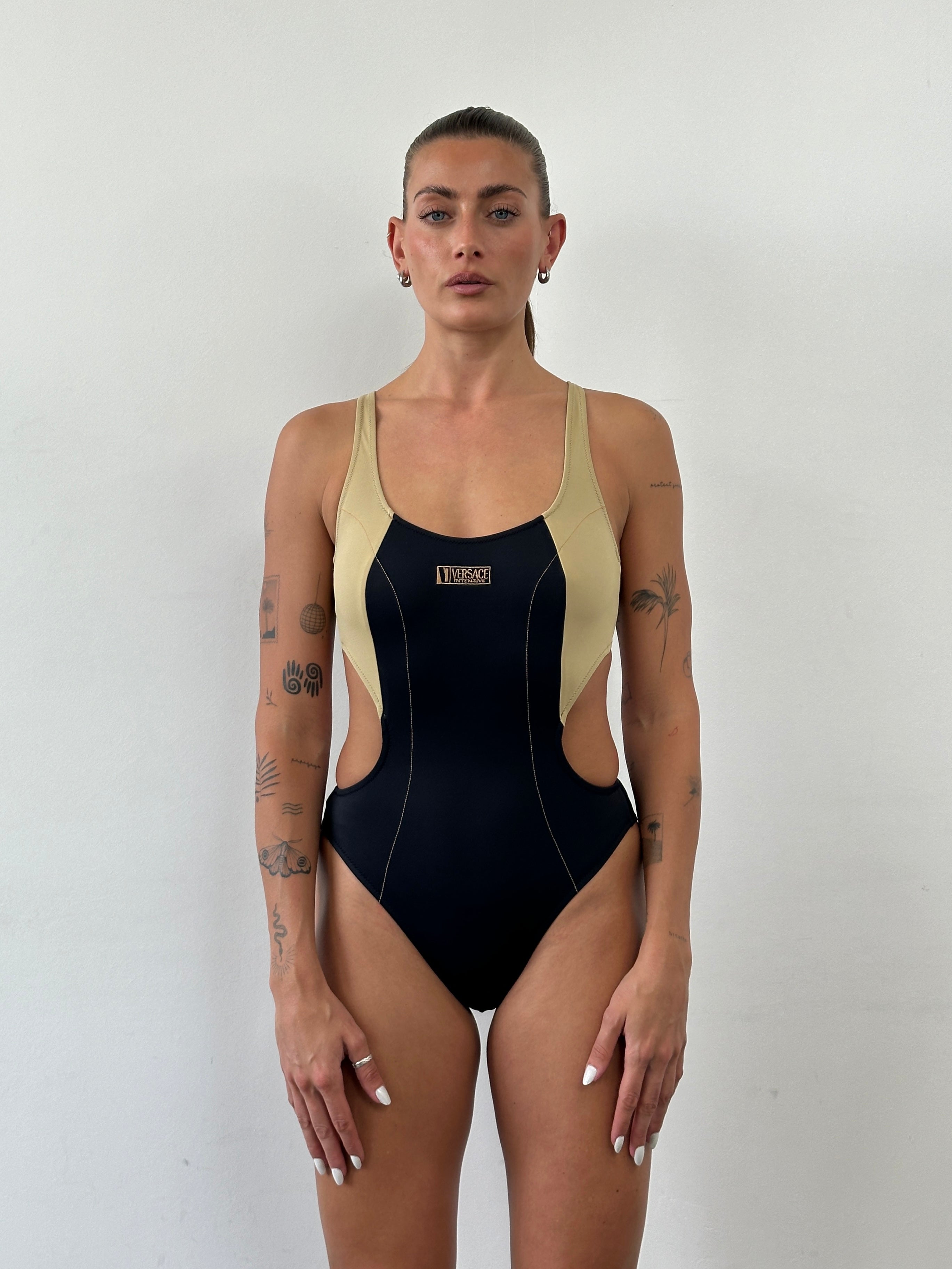 Versace Intensive 1990s high cut logo one-piece swimsuit top in black with bold Versace branding and high cut leg design.