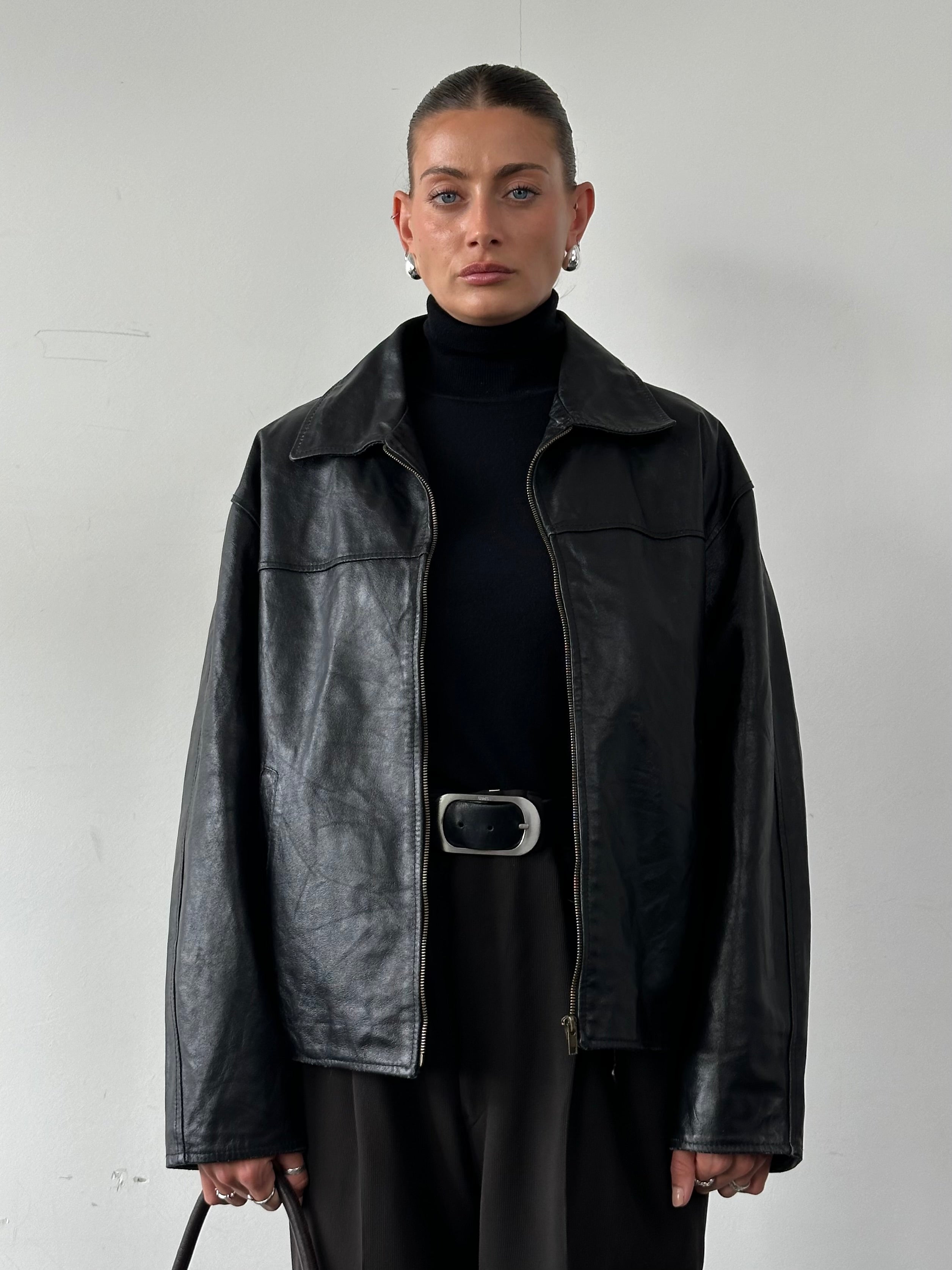 Italian Vintage Leather Jacket in size L, featuring classic design and aged leather, showcasing detailed stitching and timeless style.
