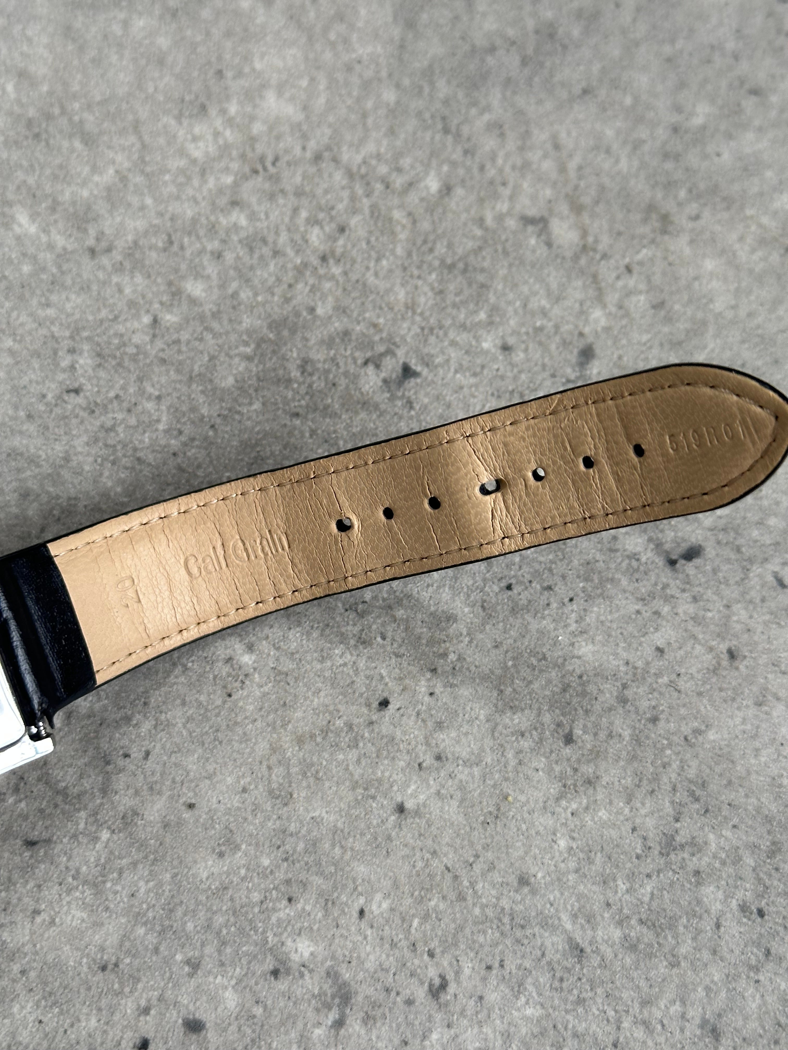 Emporio Armani 2000s rectangular stainless steel watch with leather strap, showcasing classic design and sleek metal finish.