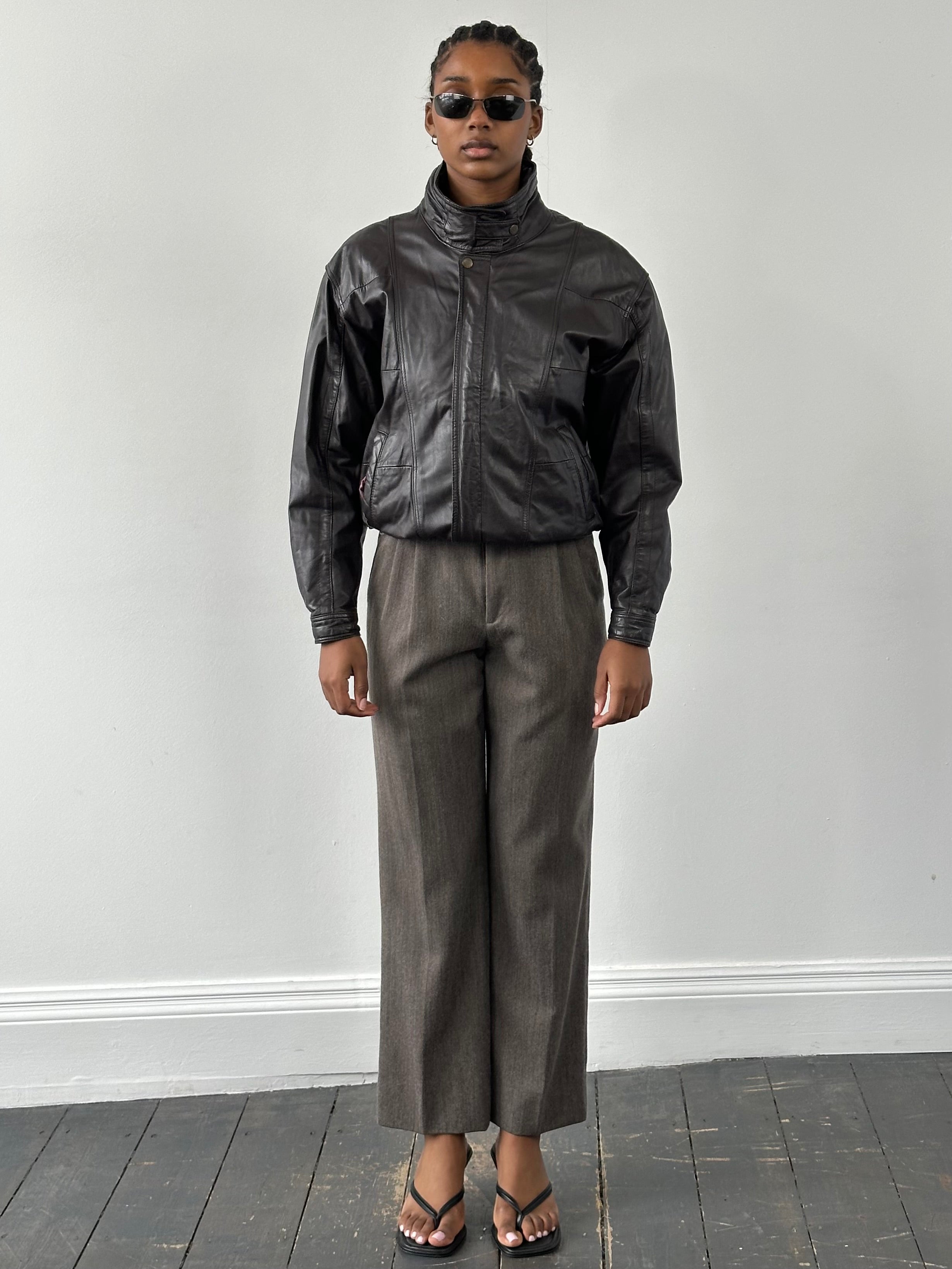 Valentino 1990s high neck leather bomber jacket in black, showing the textured leather material and high collar design.