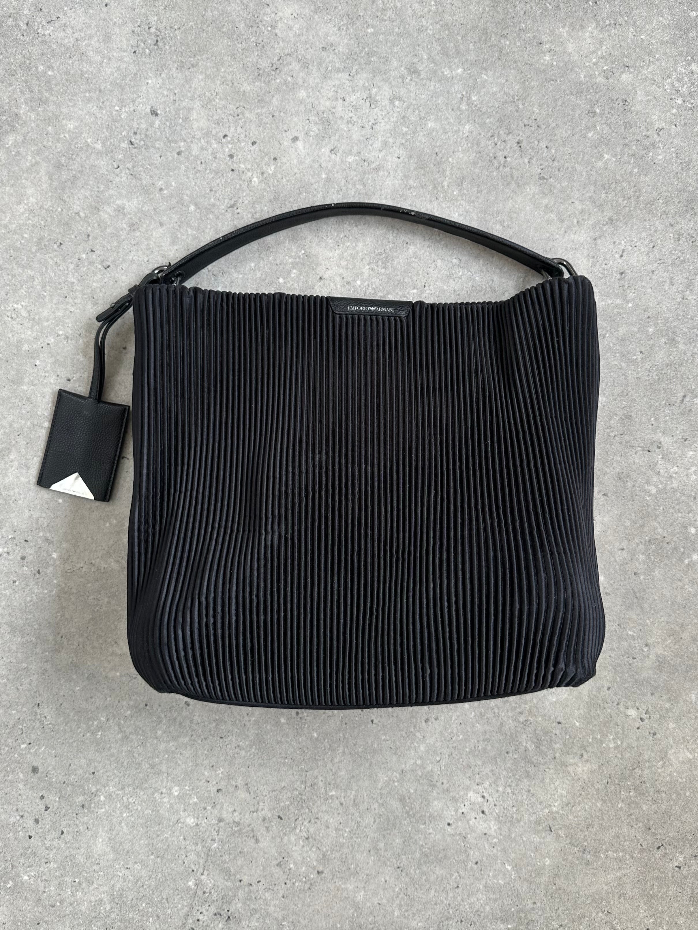 Emporio Armani pleated shoulder bag in neutral color with sleek design and adjustable strap, showcasing the brand's luxury style.