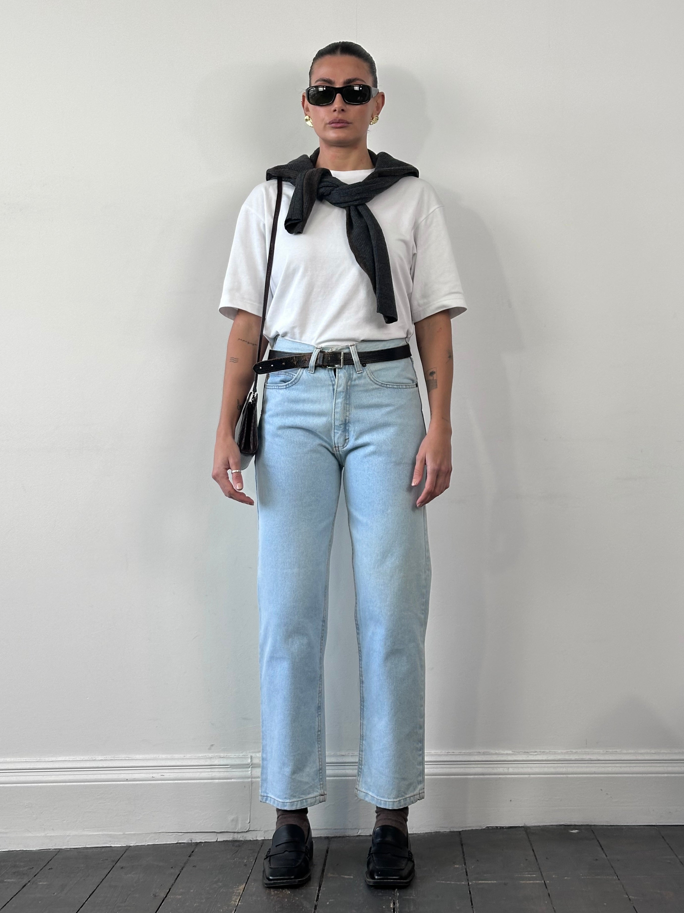 Armani Jeans light wash tapered leg denim jeans in size W26, featuring classic five-pocket design and subtle fading details.