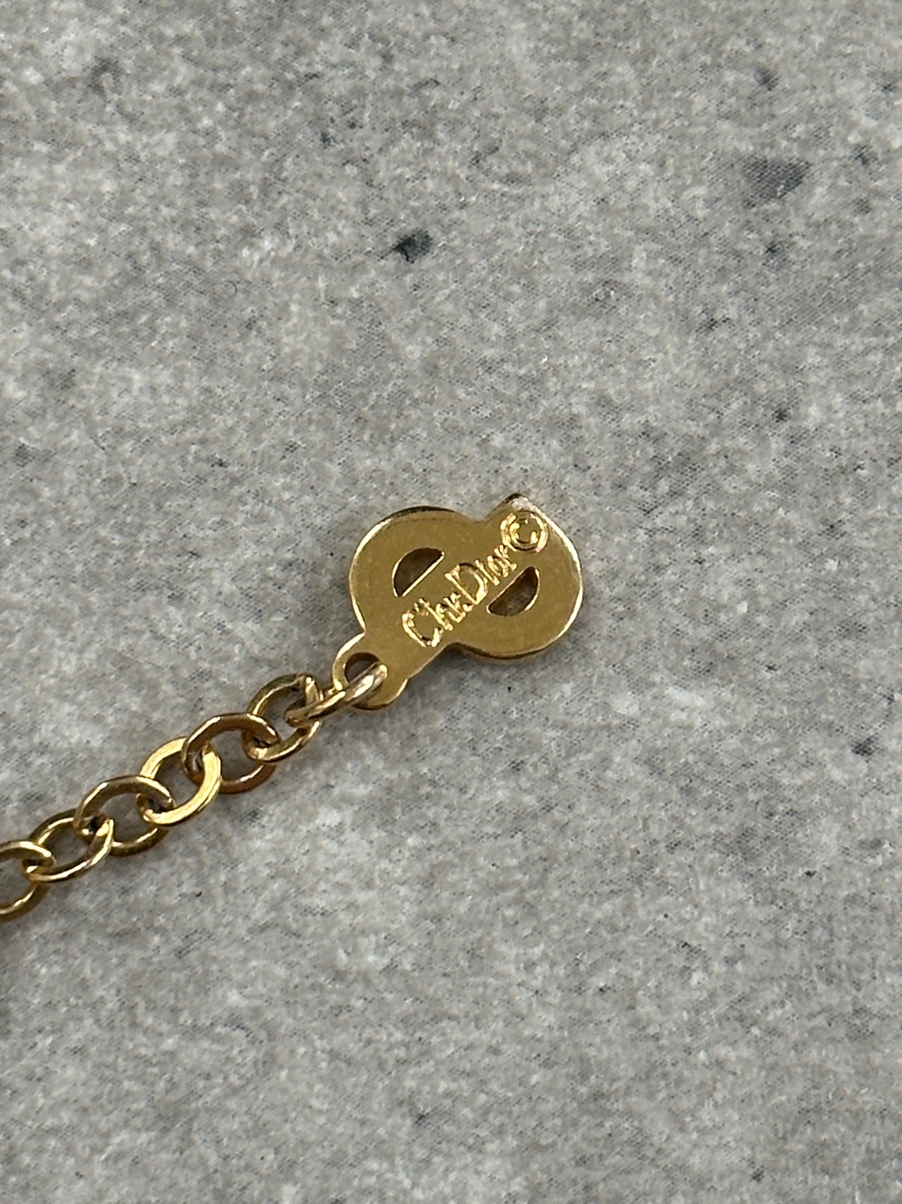 Christian Dior gold plated logo pendant necklace, 16 inches long, featuring a sleek and stylish design with the brand's signature emblem.