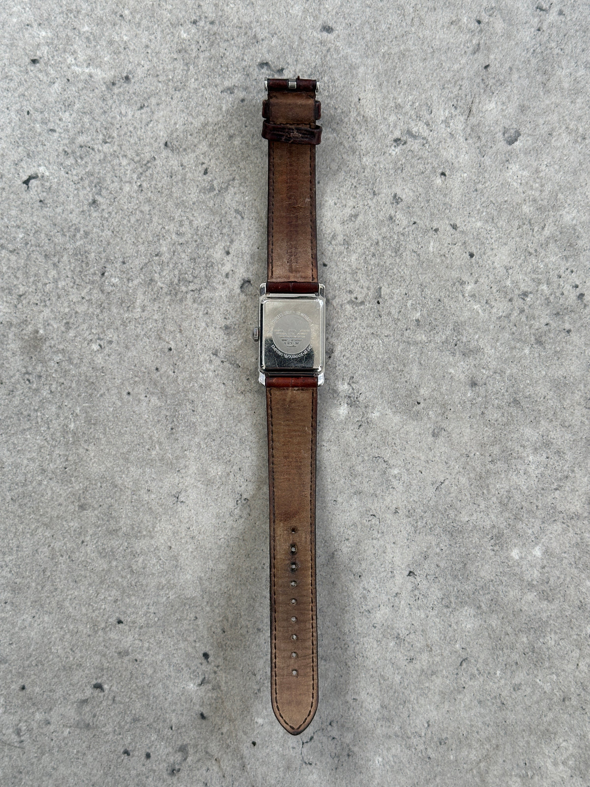 Emporio Armani 2000s leather rectangular quartz watch with silver dial and black leather strap, showcasing a classic fashion accessory.