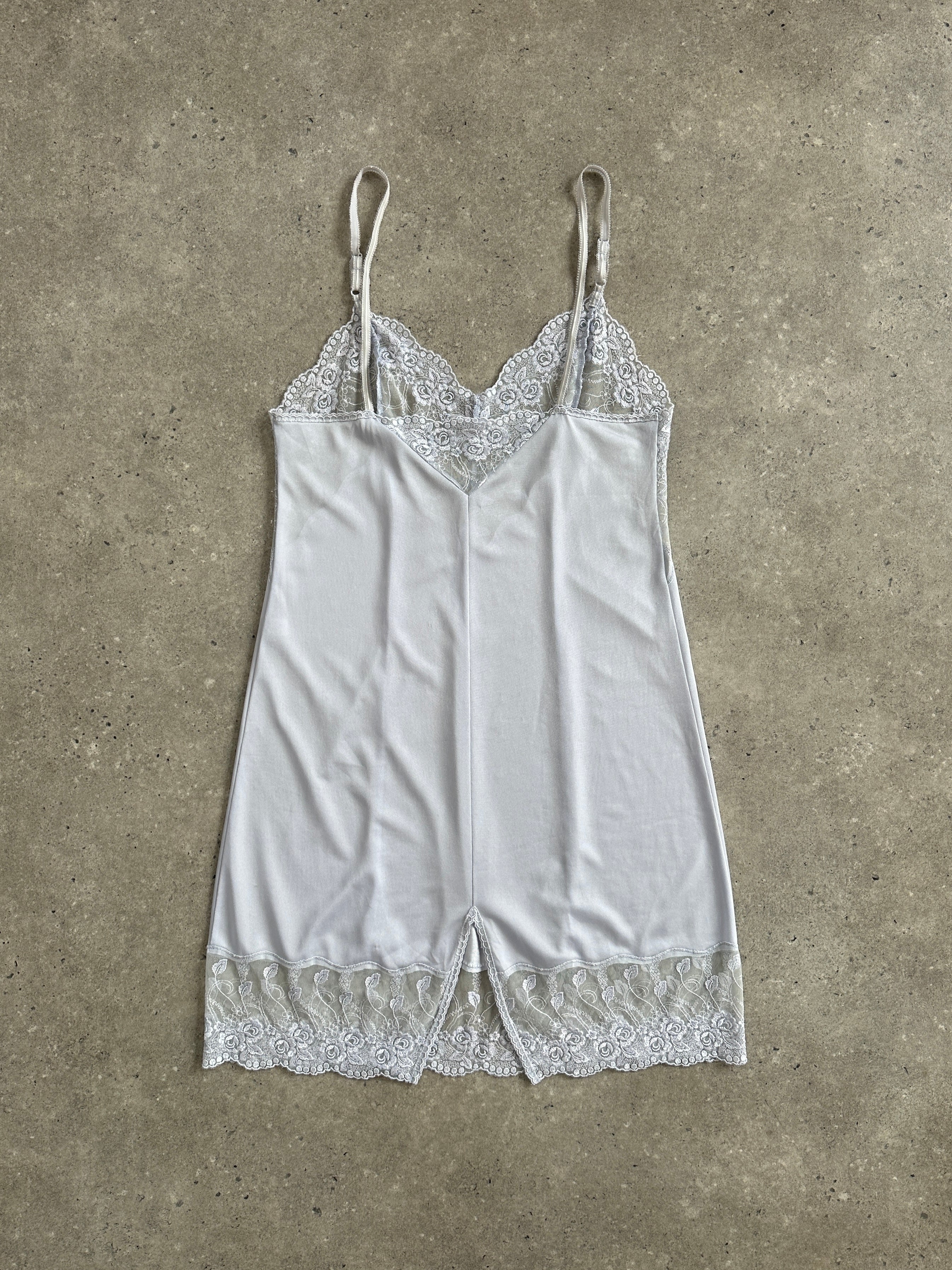 Vintage 1990s lace sheer mini slip dress in size S, featuring delicate lace fabric and a classic vintage design.