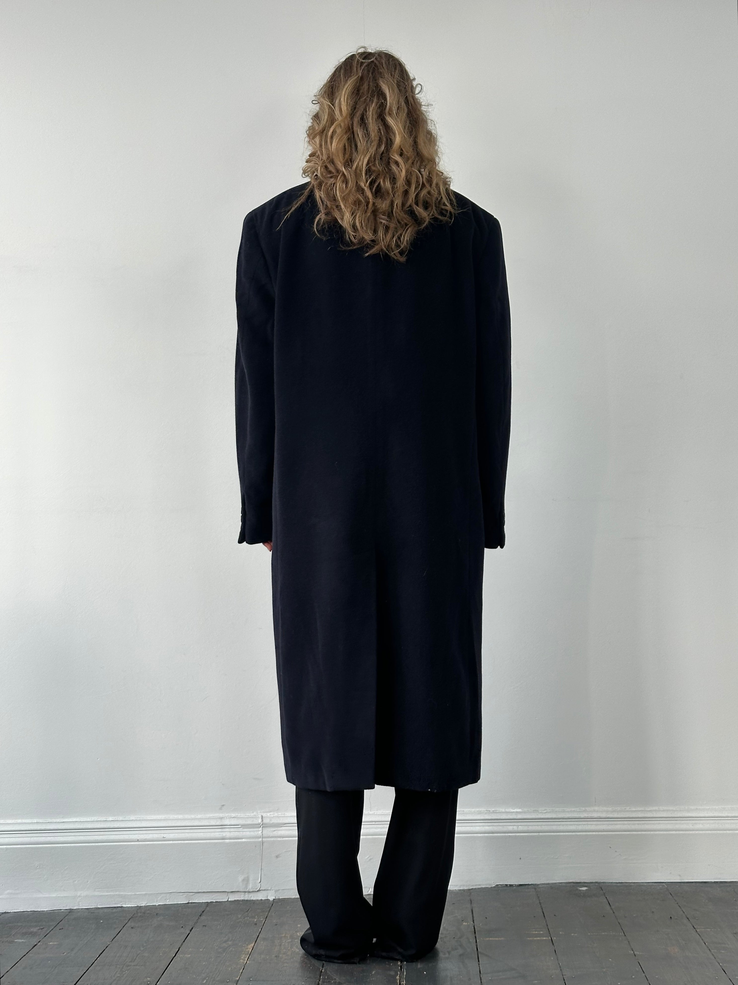 Giorgio Armani Le Collezioni pure wool single-breasted coat in XXL, shown hanging on a wooden hanger with a classic collar.