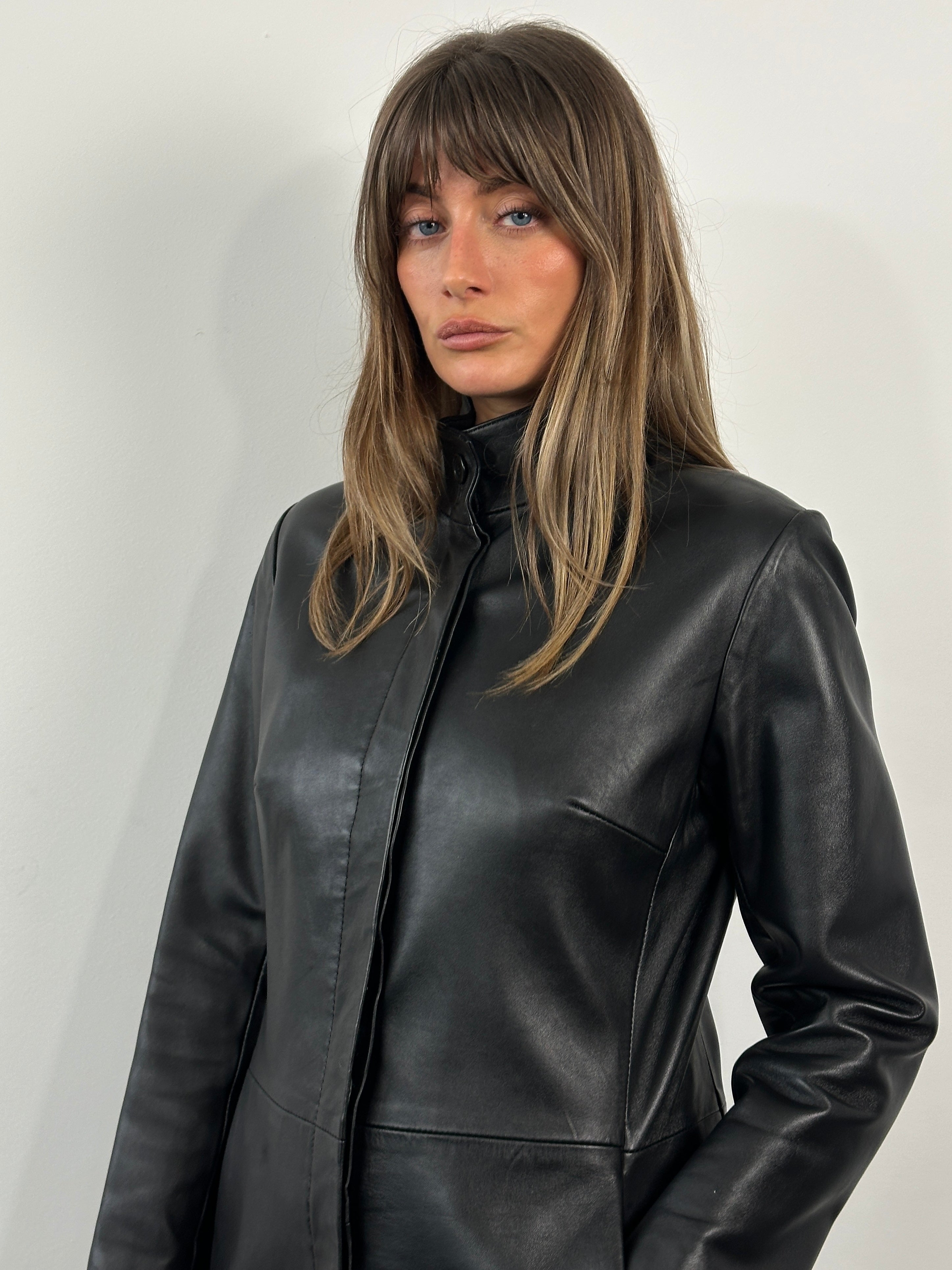 Vintage 1990s minimal high neck leather trench coat, size small, featuring classic design and sleek dark leather material.