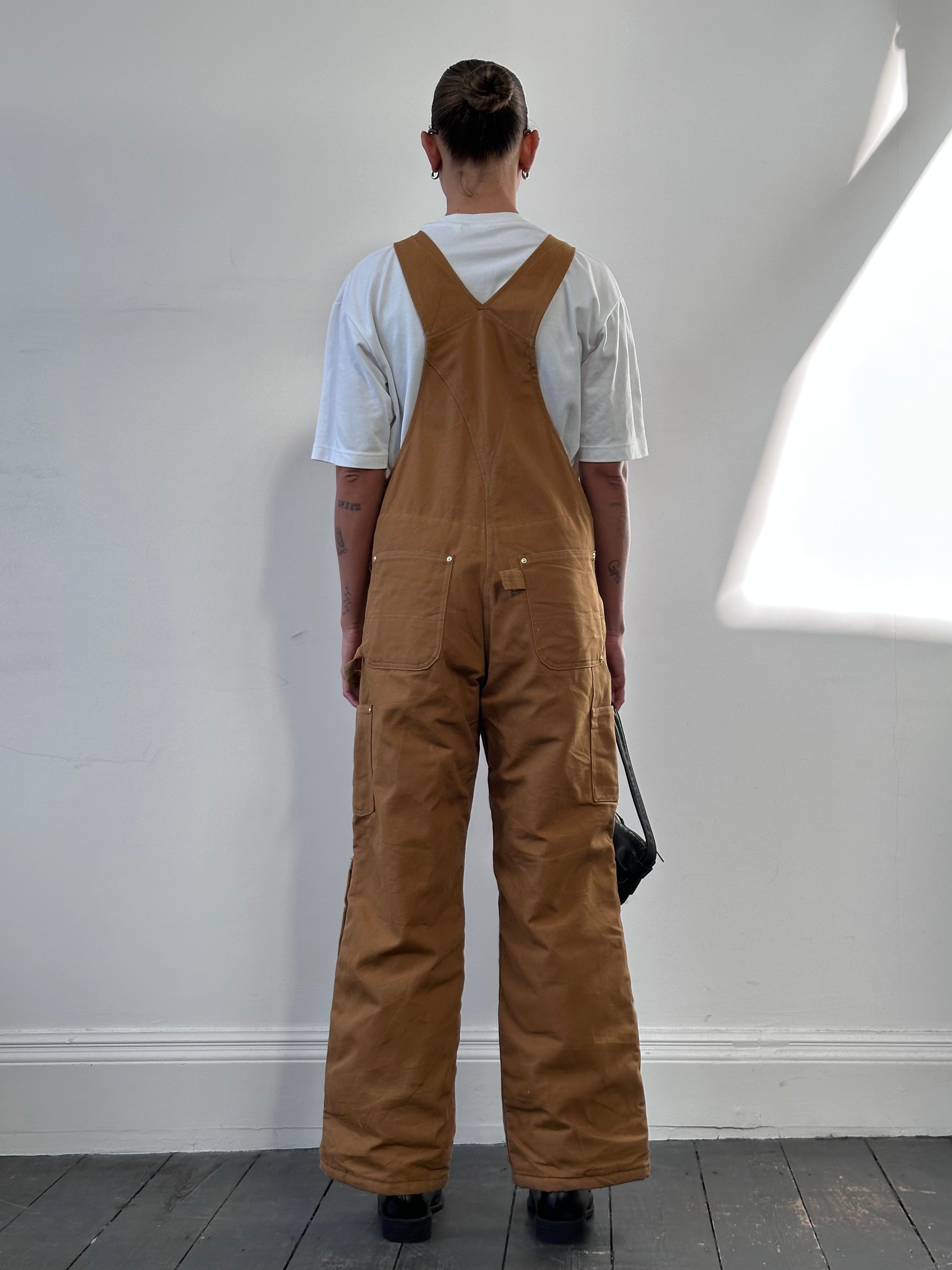 Carhartt pure cotton dungarees in size M, featuring durable fabric and classic design, displayed on a neutral background.