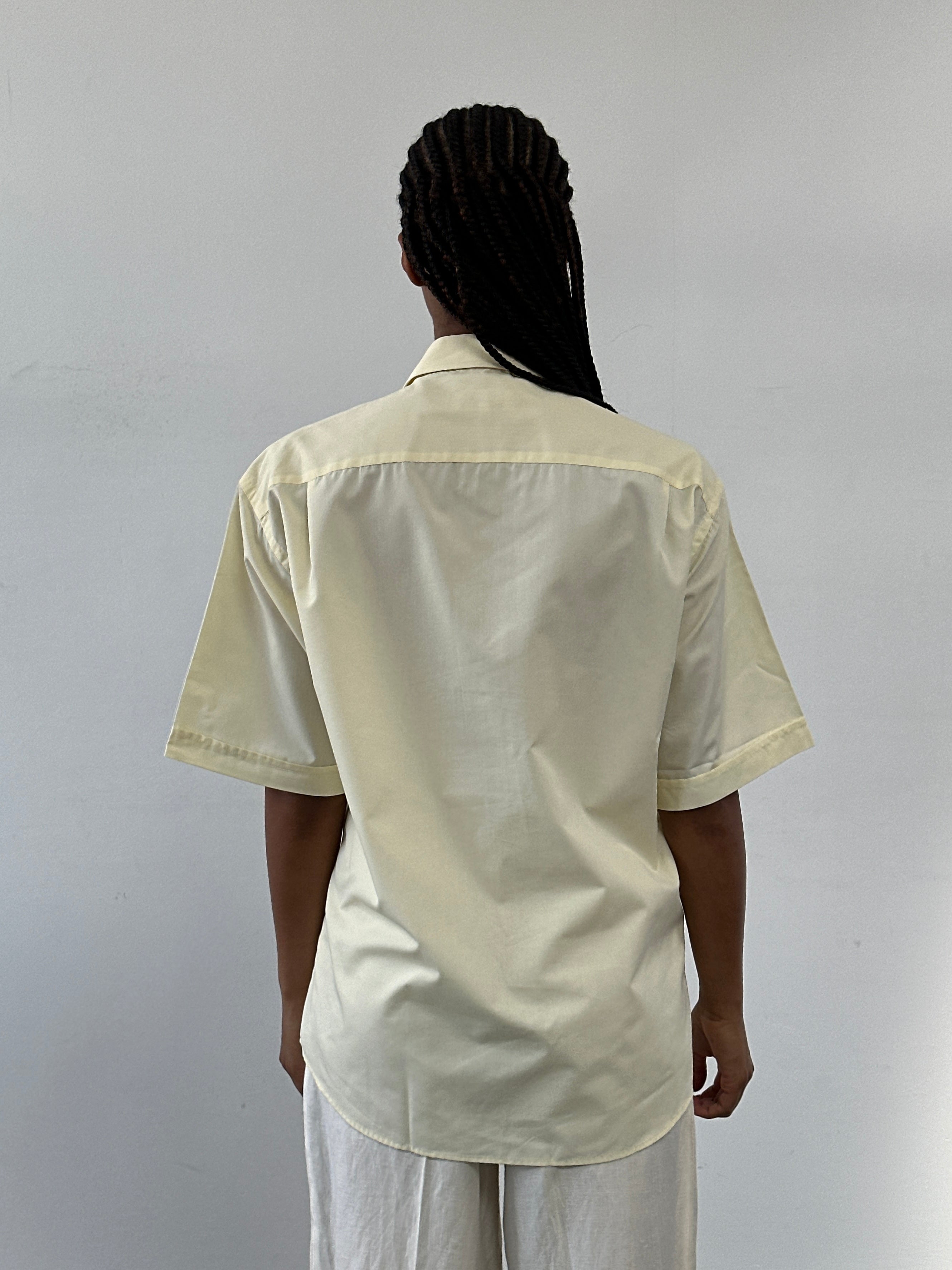 Yves Saint Laurent Pour Homme 1990s cotton short sleeve logo shirt in size L, featuring classic design and branded logo on front.