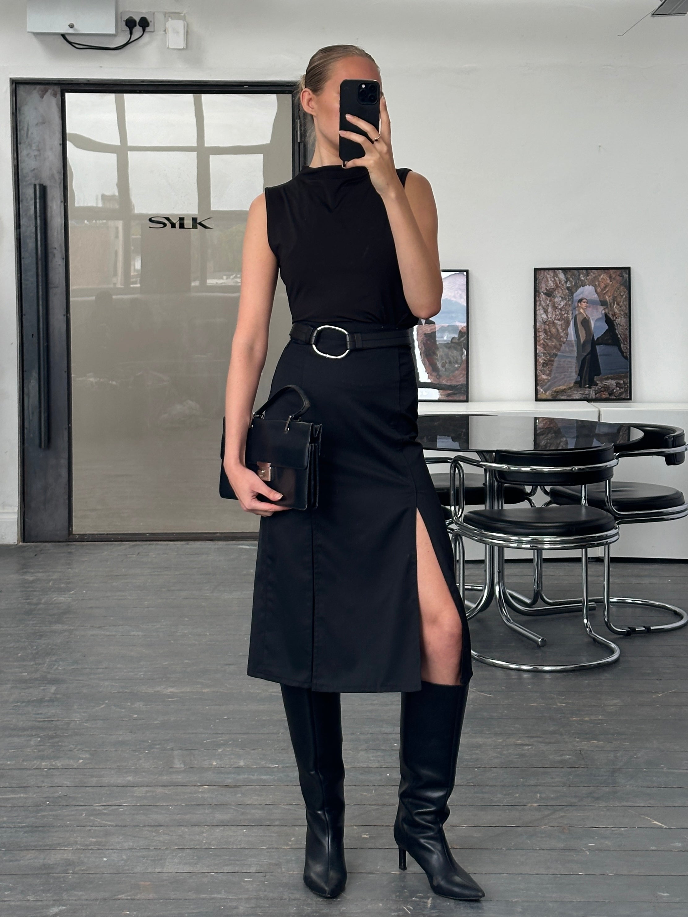 Vintage 1990s pleated midi skirt, size W26, featuring classic design and fabric, displayed on a neutral background.