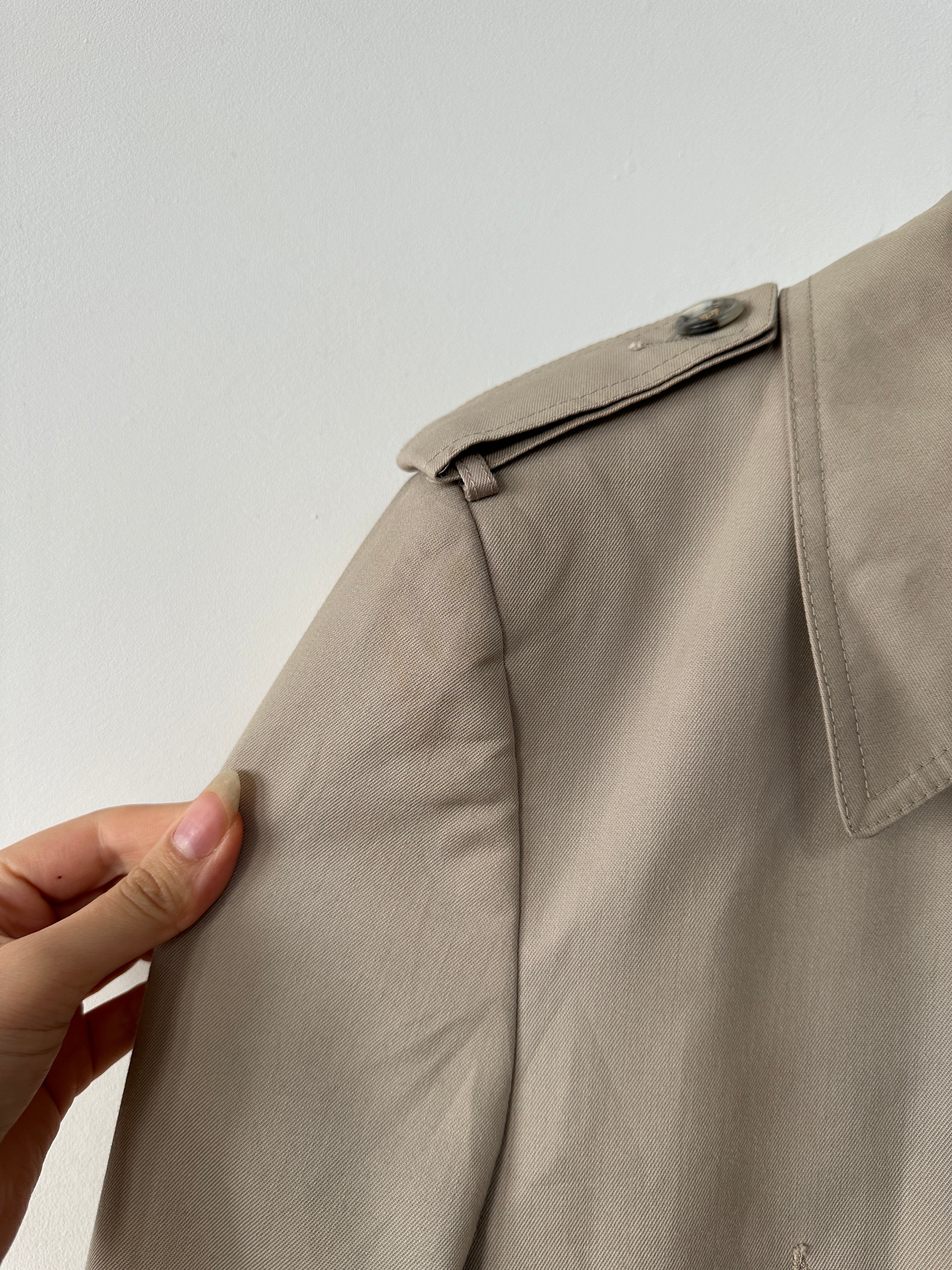 Christian Dior double-breasted trench coat in XL/XXL, shown hanging with classic beige fabric and tailored design