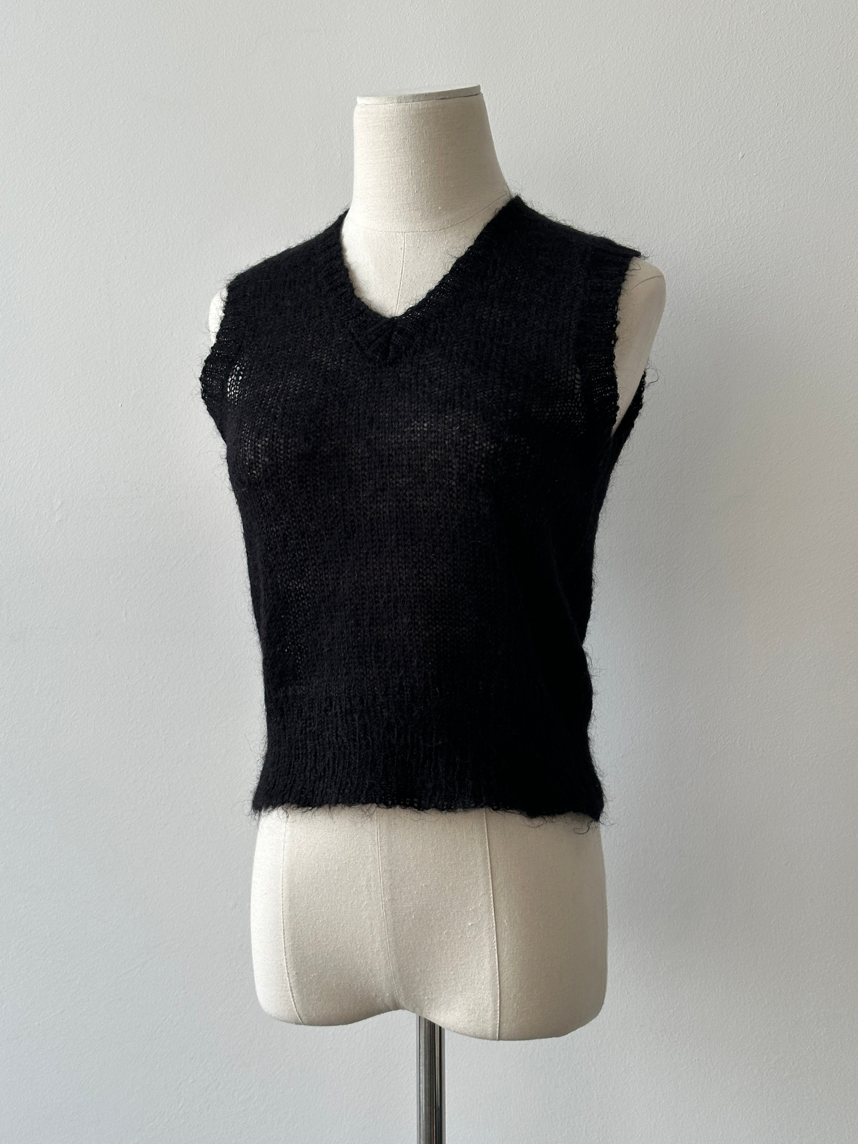 Vintage 1990s mohair v-neck top in soft beige, featuring a classic fit and textured fabric, displayed on a hanger.