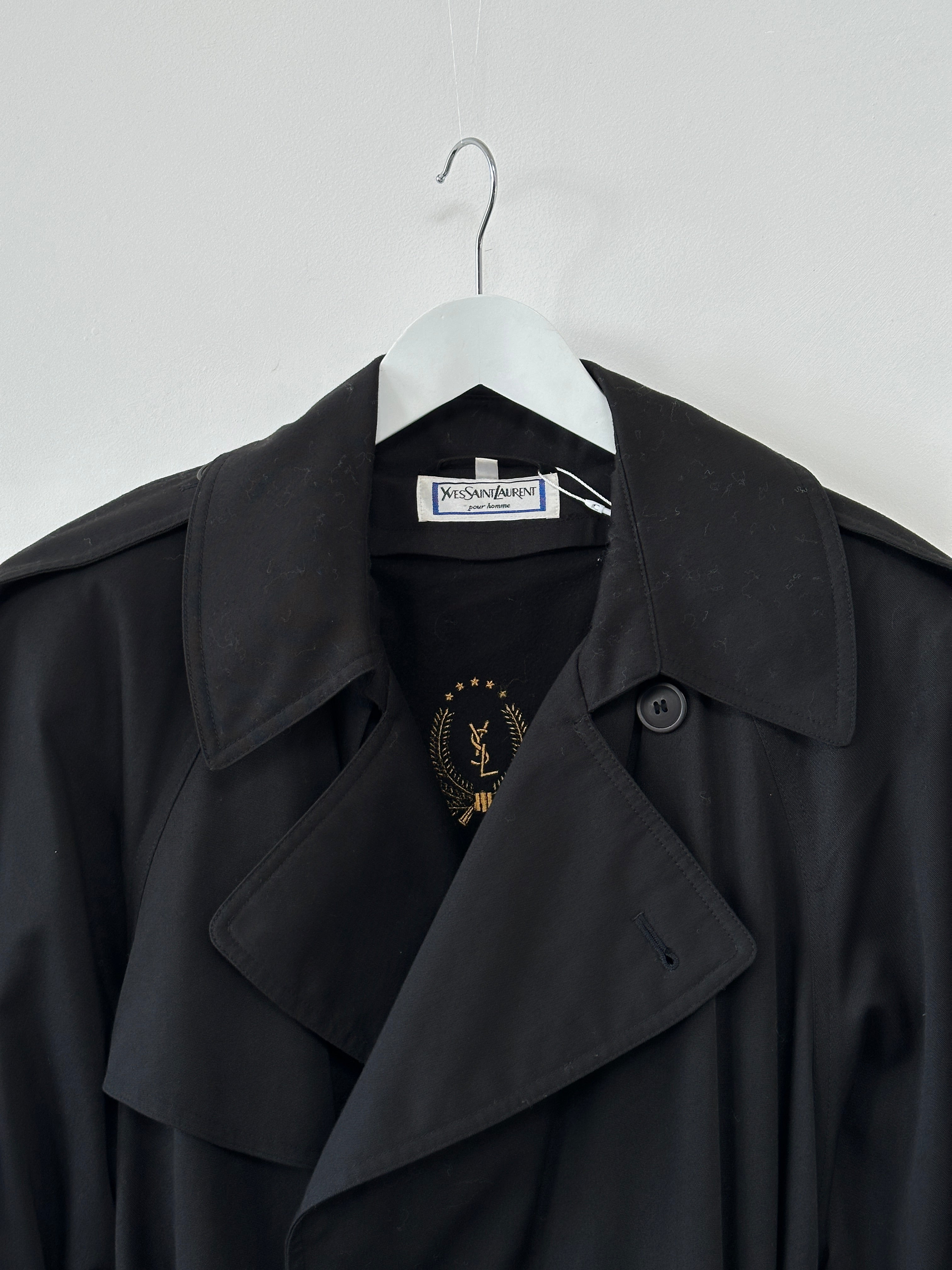 Yves Saint Laurent Pour Homme XXL cotton belted trench coat displayed on a hanger, featuring classic design and neutral color.