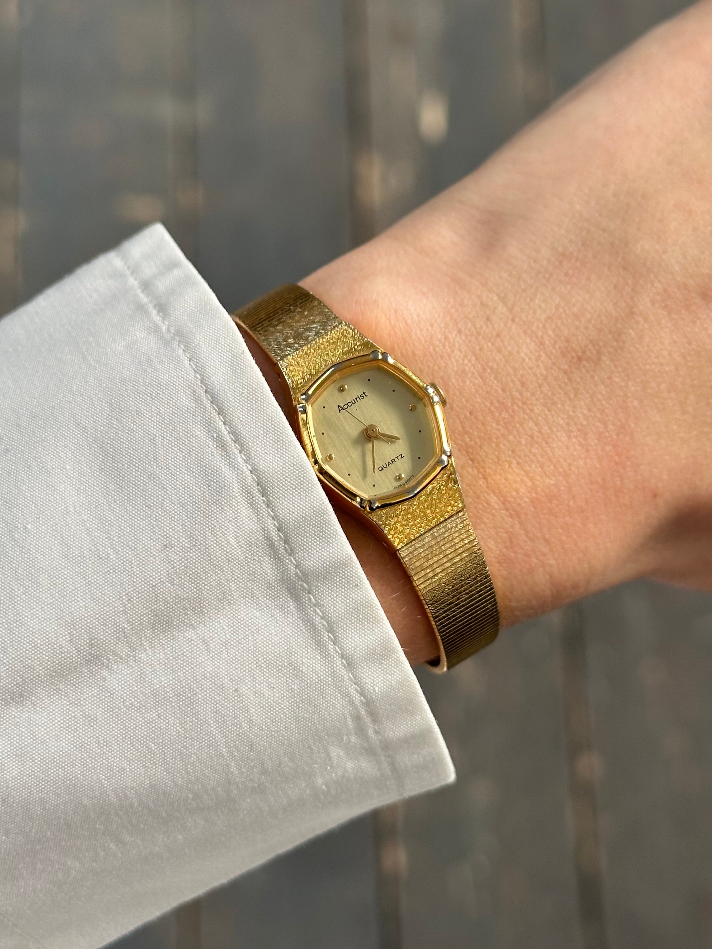 Accurist 1990s gold-tone octagonal quartz watch with a sleek design and detailed dial, showcasing vintage style and craftsmanship.