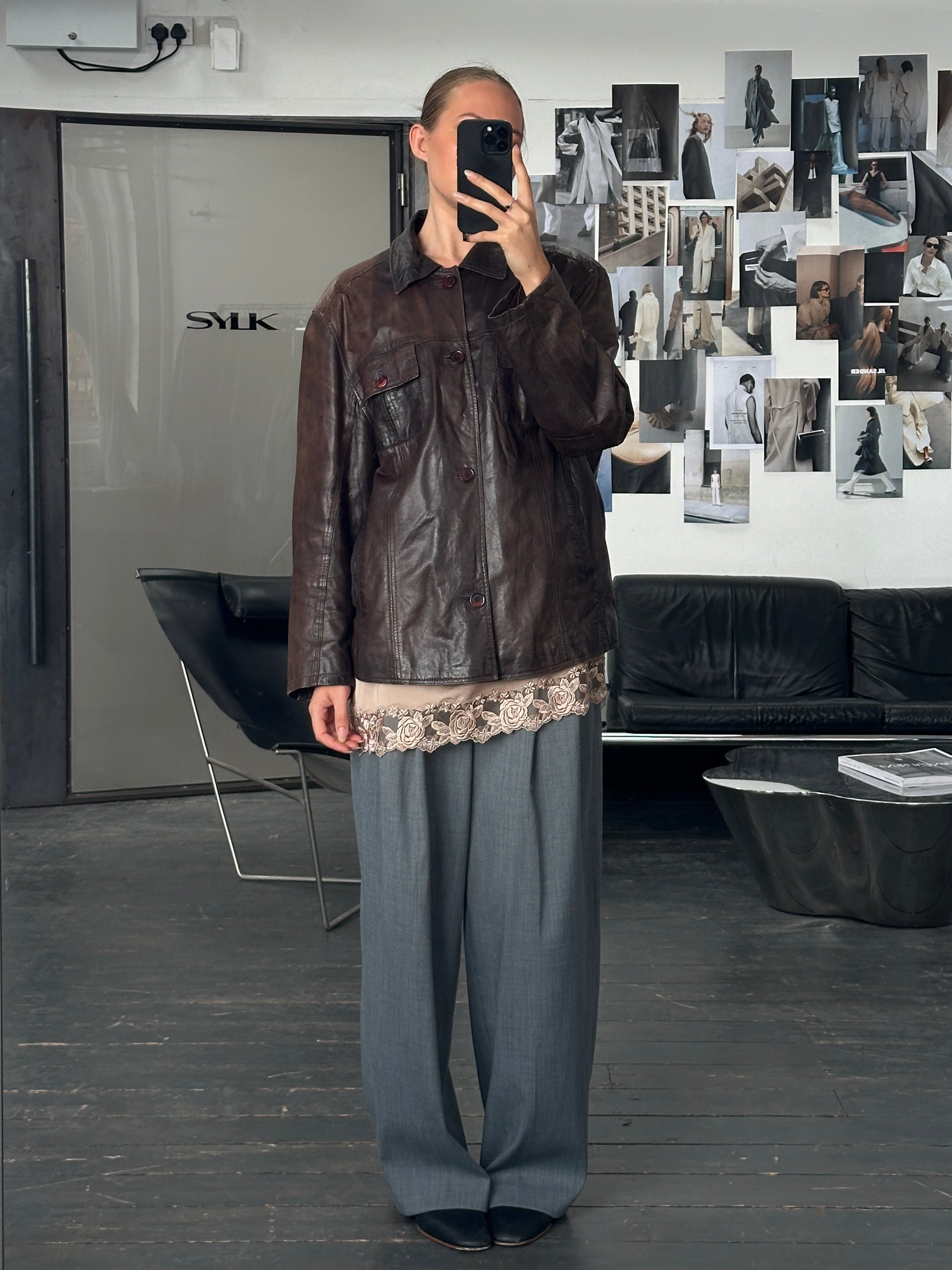 Vintage 1990s aged leather jacket in XL, showcasing distressed leather and classic design with a collar and front zipper.