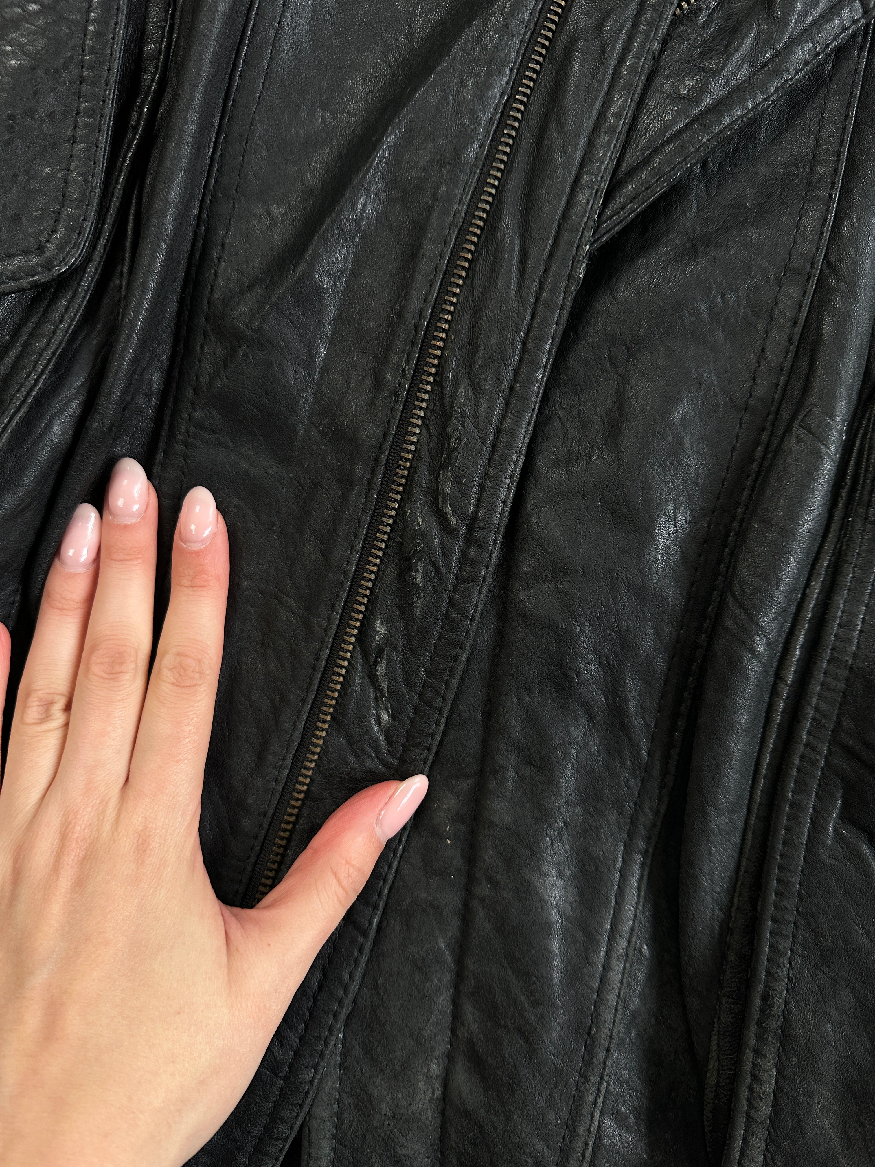 Vintage distressed leather bomber jacket in size large, featuring rugged details and classic design.