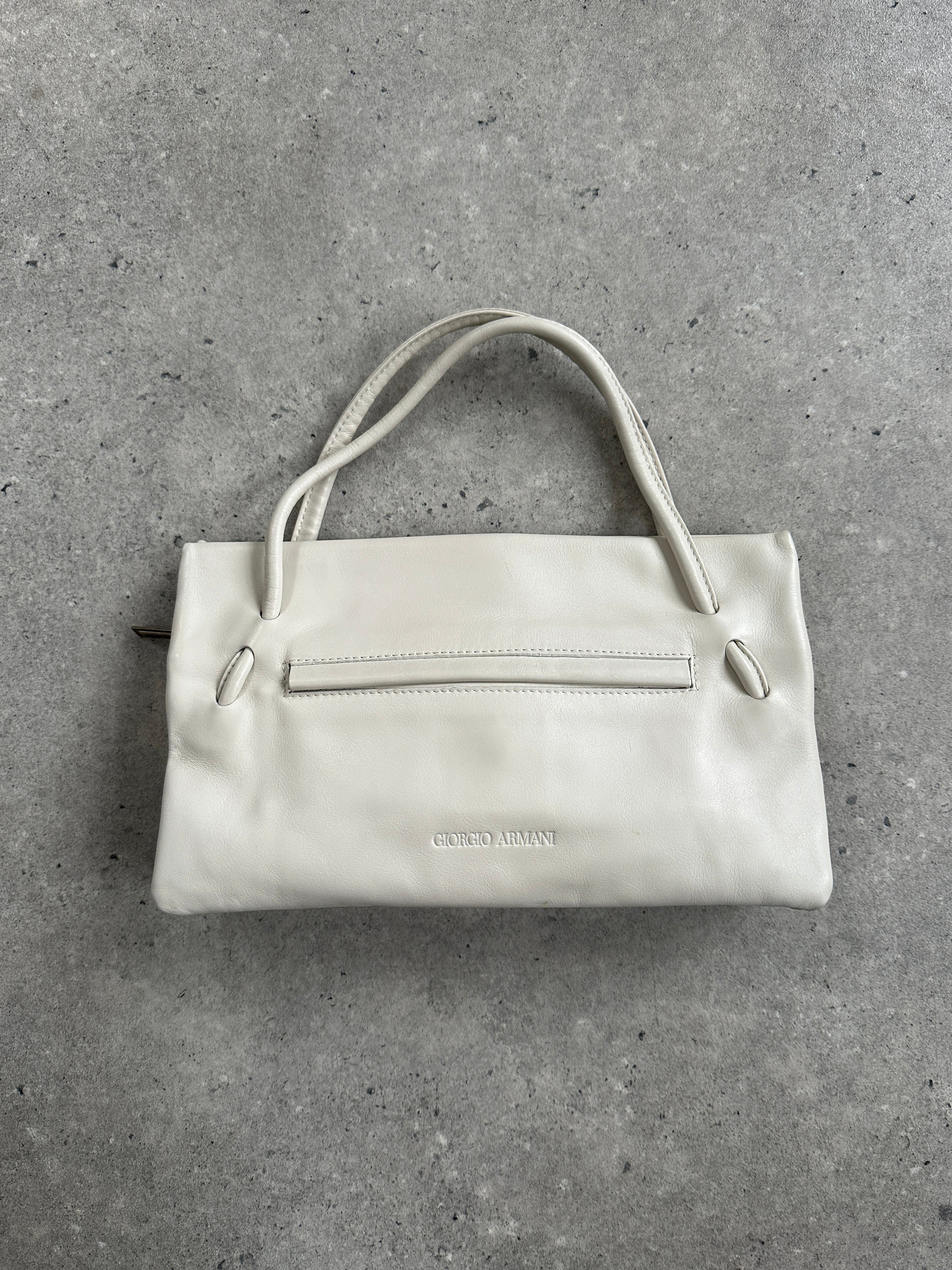 Giorgio Armani Le Collezioni embossed logo handbag with textured leather and sleek design, classic accessory for elegant style.