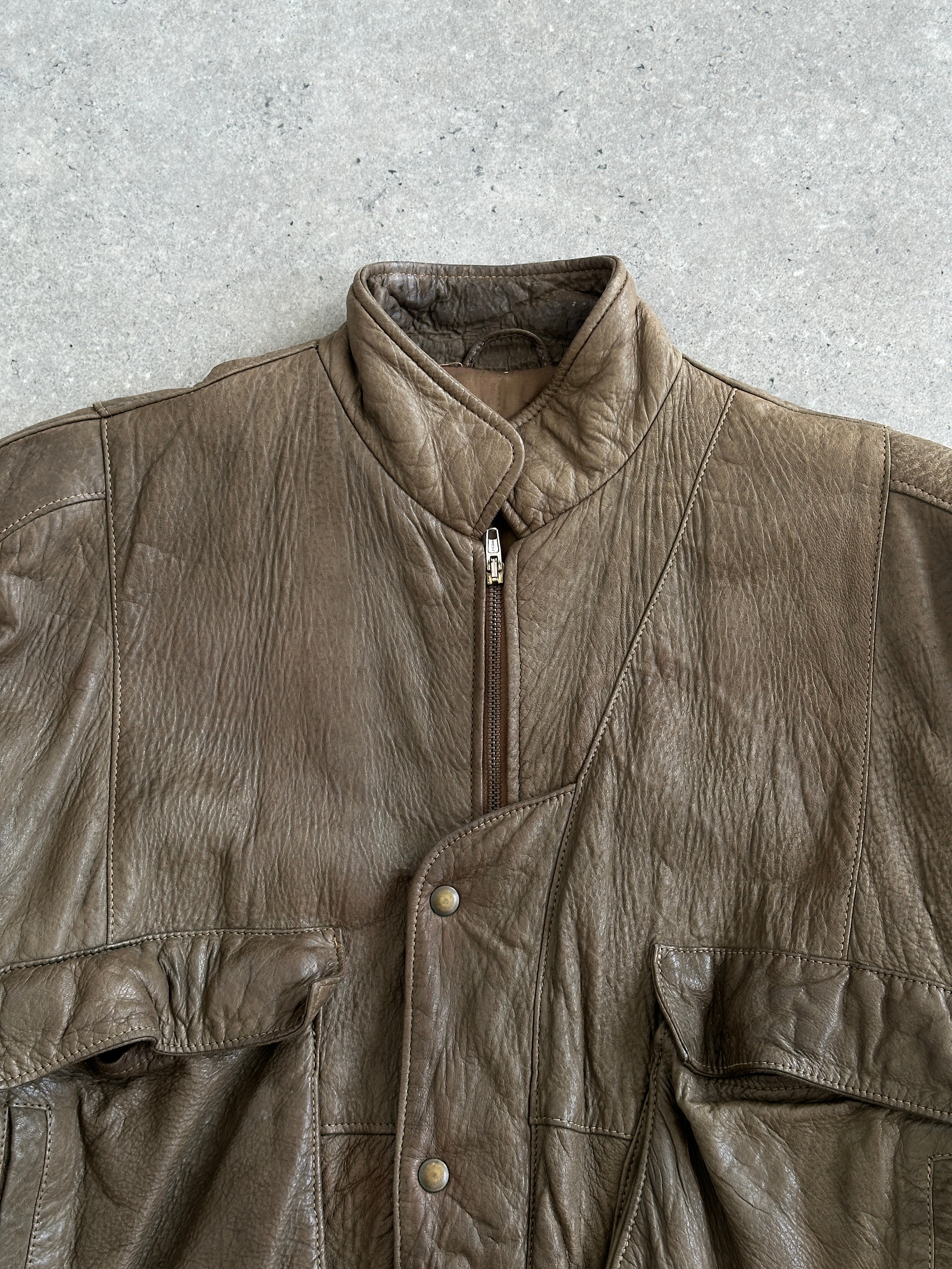 Vintage 1980s leather moto jacket in size large, featuring classic black leather with metal zip details and a fitted style.