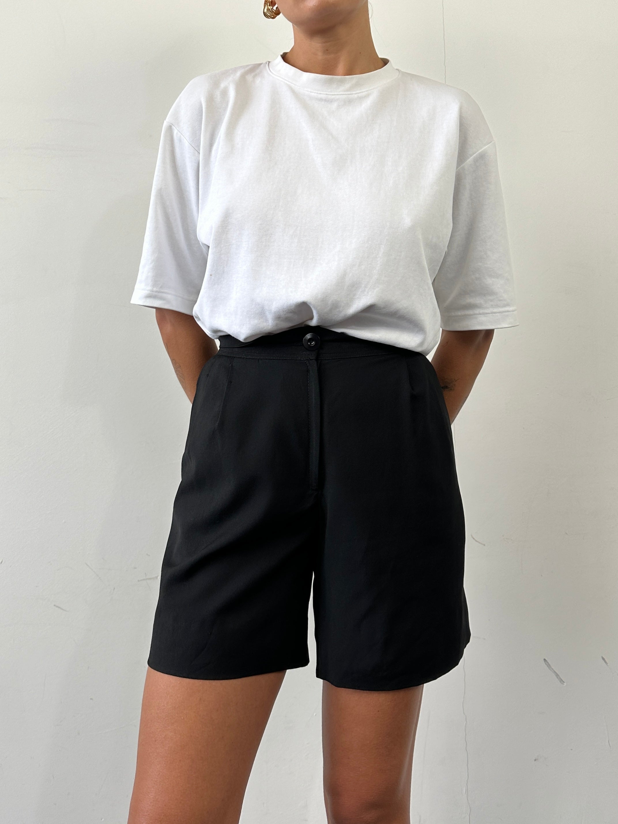 Vintage cotton high-waisted pleated shorts in W24 with a classic design, laid flat to showcase the front details.