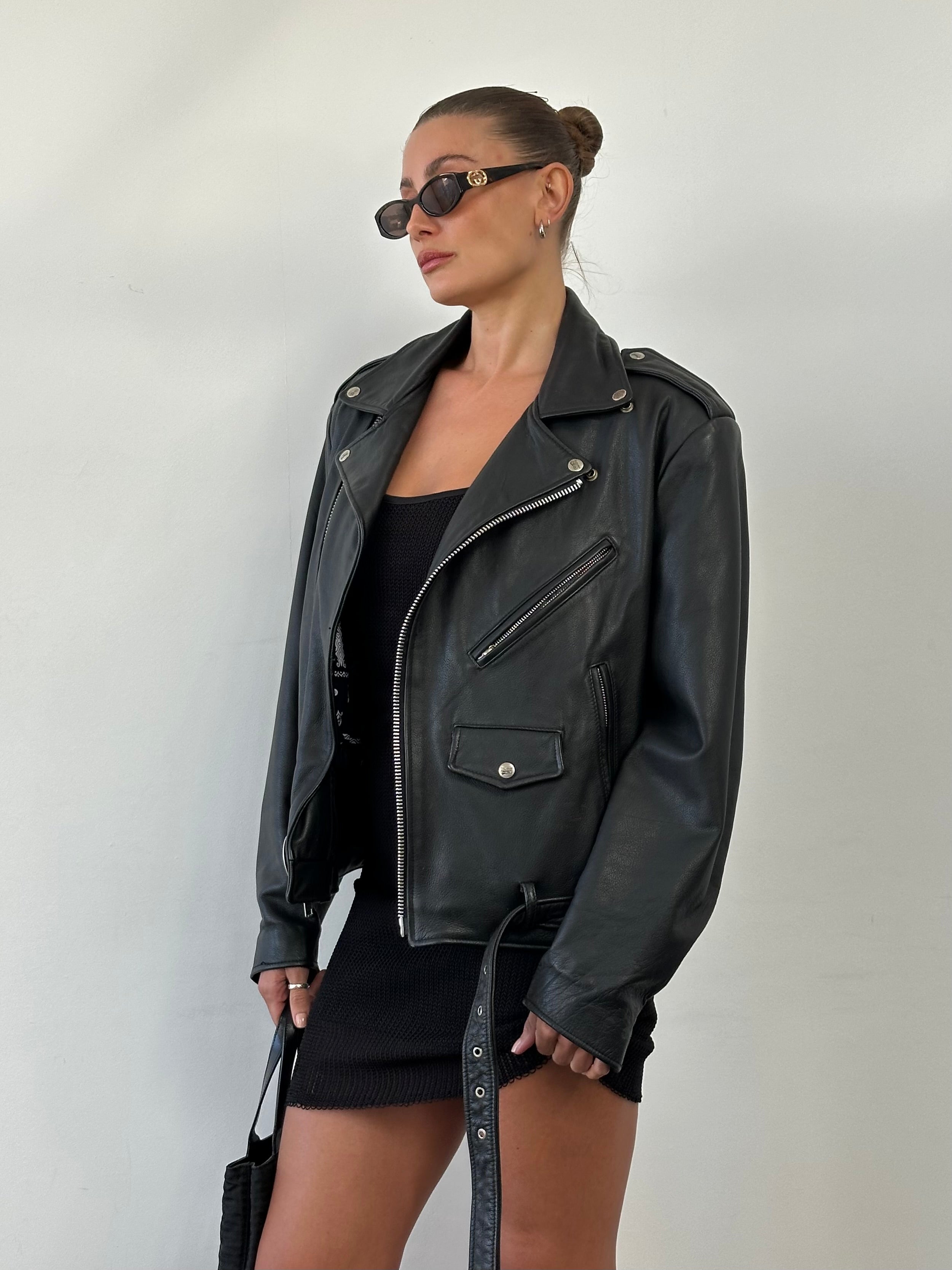 Vintage Leather Biker Jacket in size M/L, featuring classic design with rugged leather and metal hardware for a timeless edgy look.