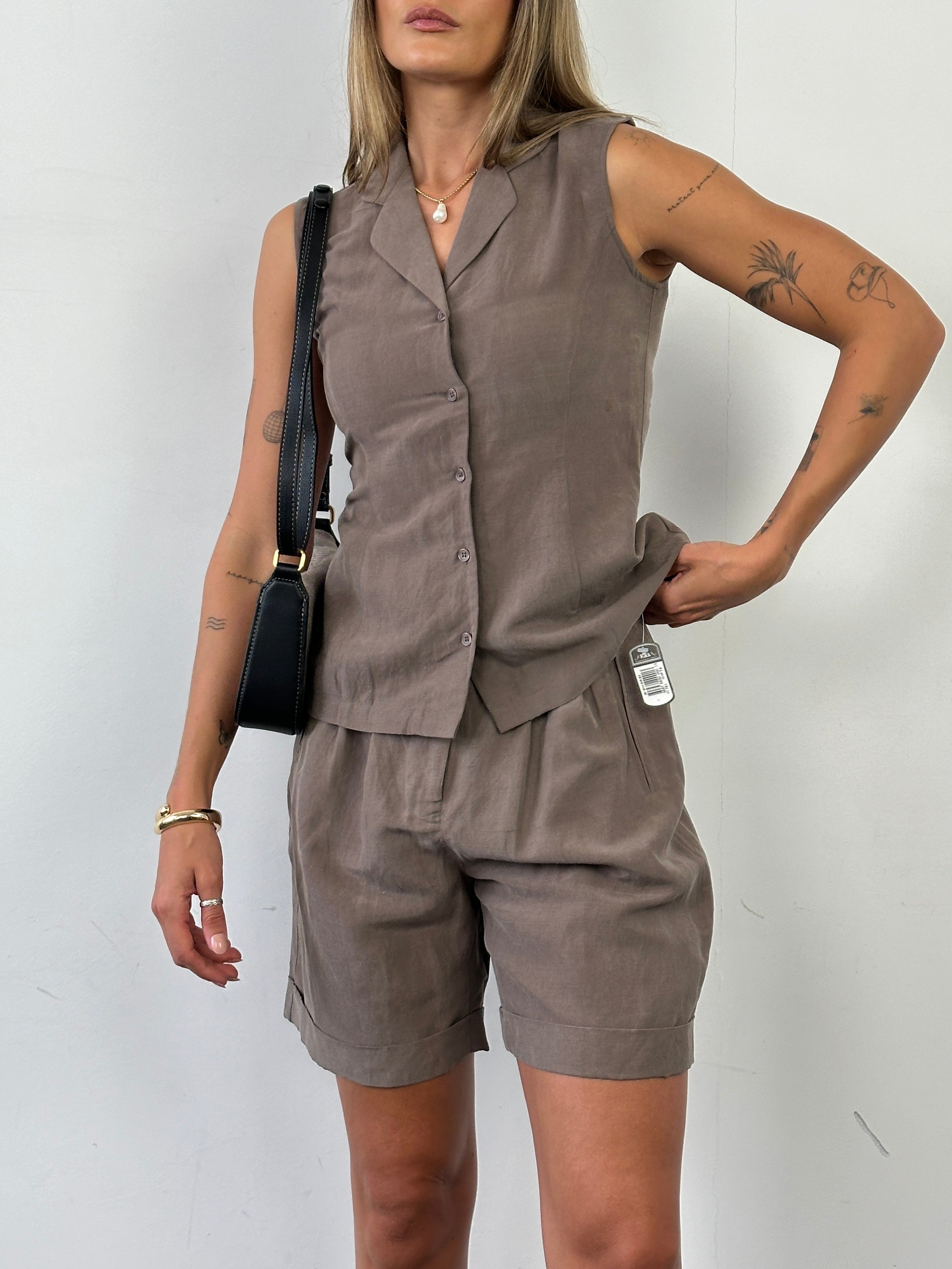 Vintage silk linen waistcoat and shorts two-piece suit set displayed on a hanger, featuring a classic vintage style in neutral tones.