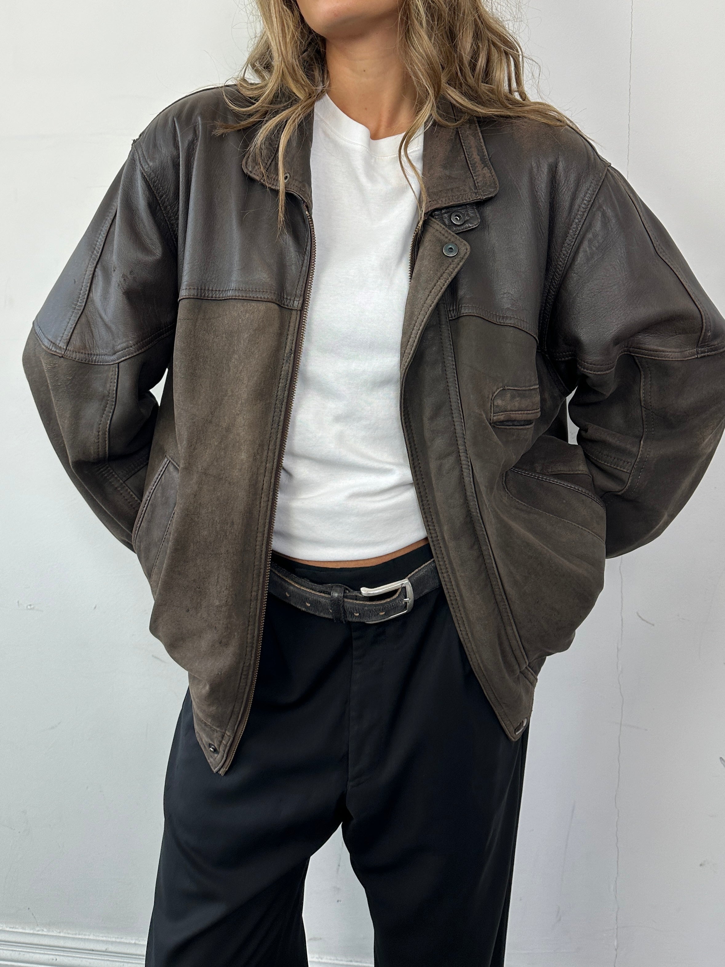 Vintage aged leather bomber jacket in size large, featuring distressed leather and classic design details.