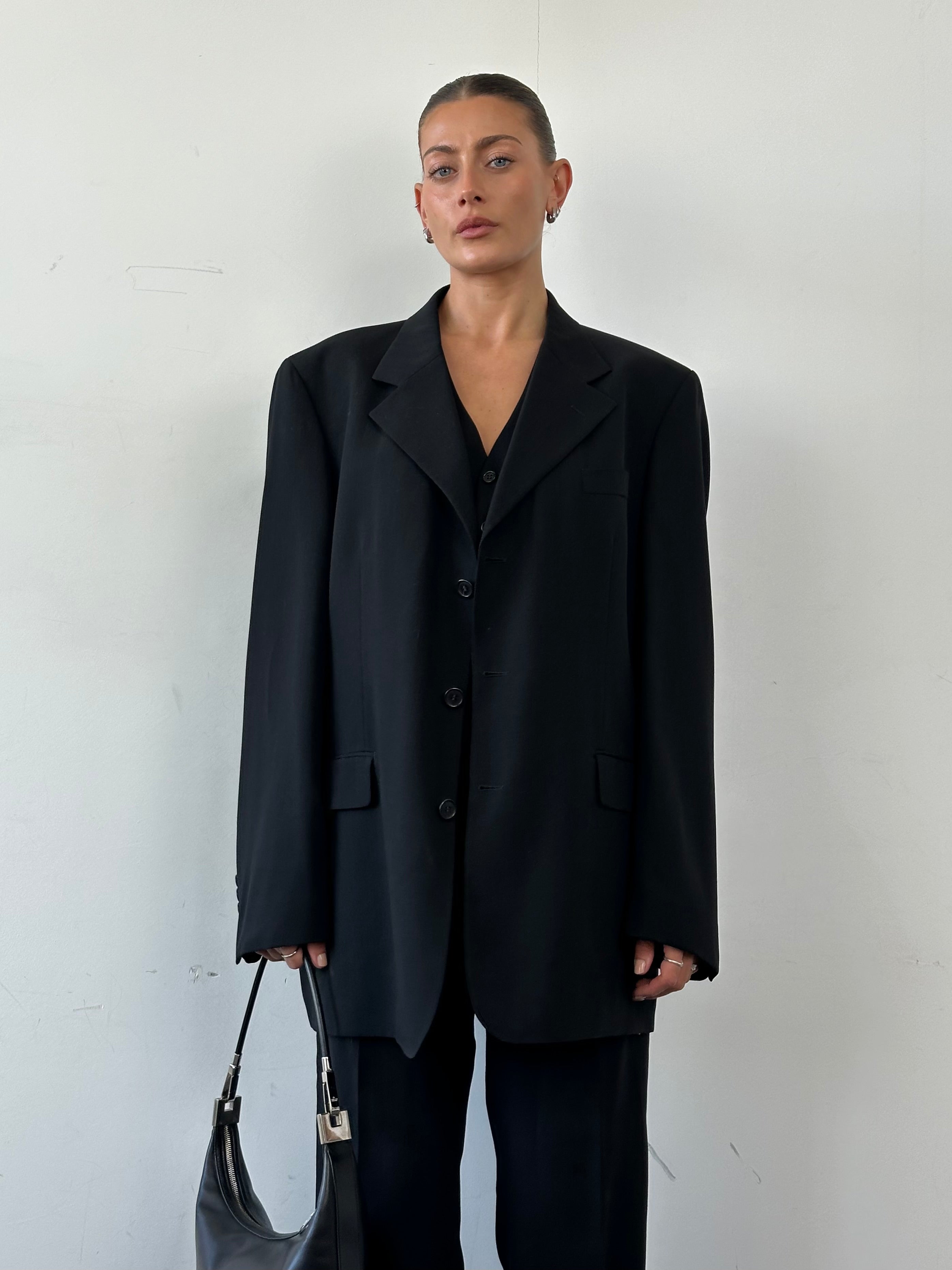 Yves Saint Laurent Pour Homme pure wool three-piece suit in size 46L/W34, styled with jacket, vest, and trousers on a mannequin.
