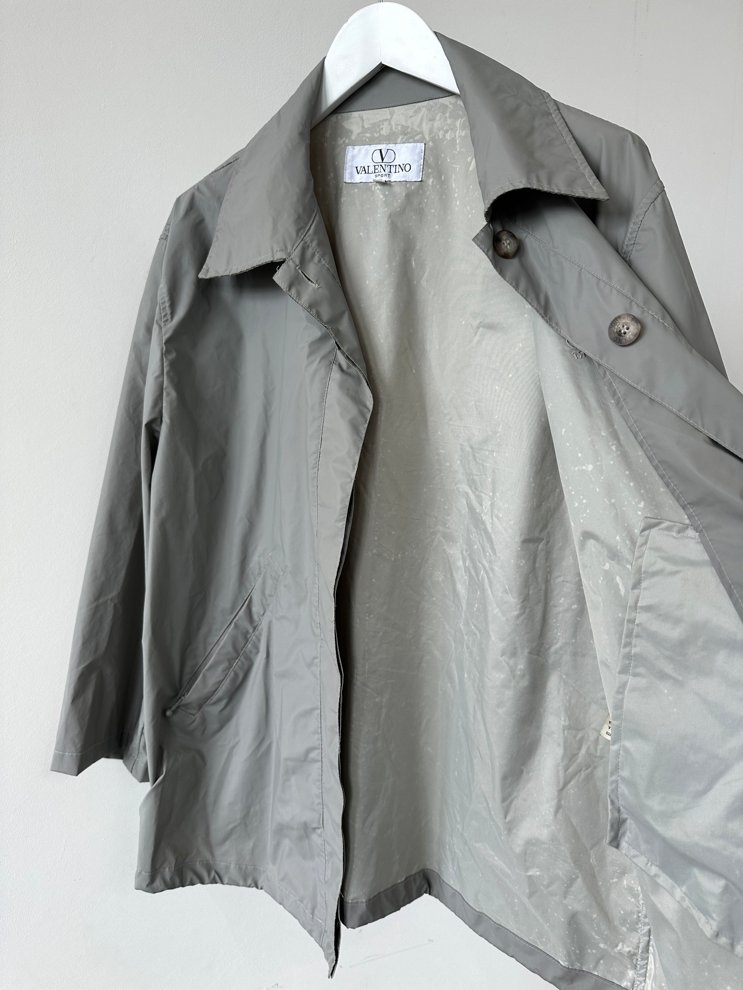 Valentino Sport raincoat jacket in size large, featuring a sleek design with a hood and waterproof material for outdoor wear.