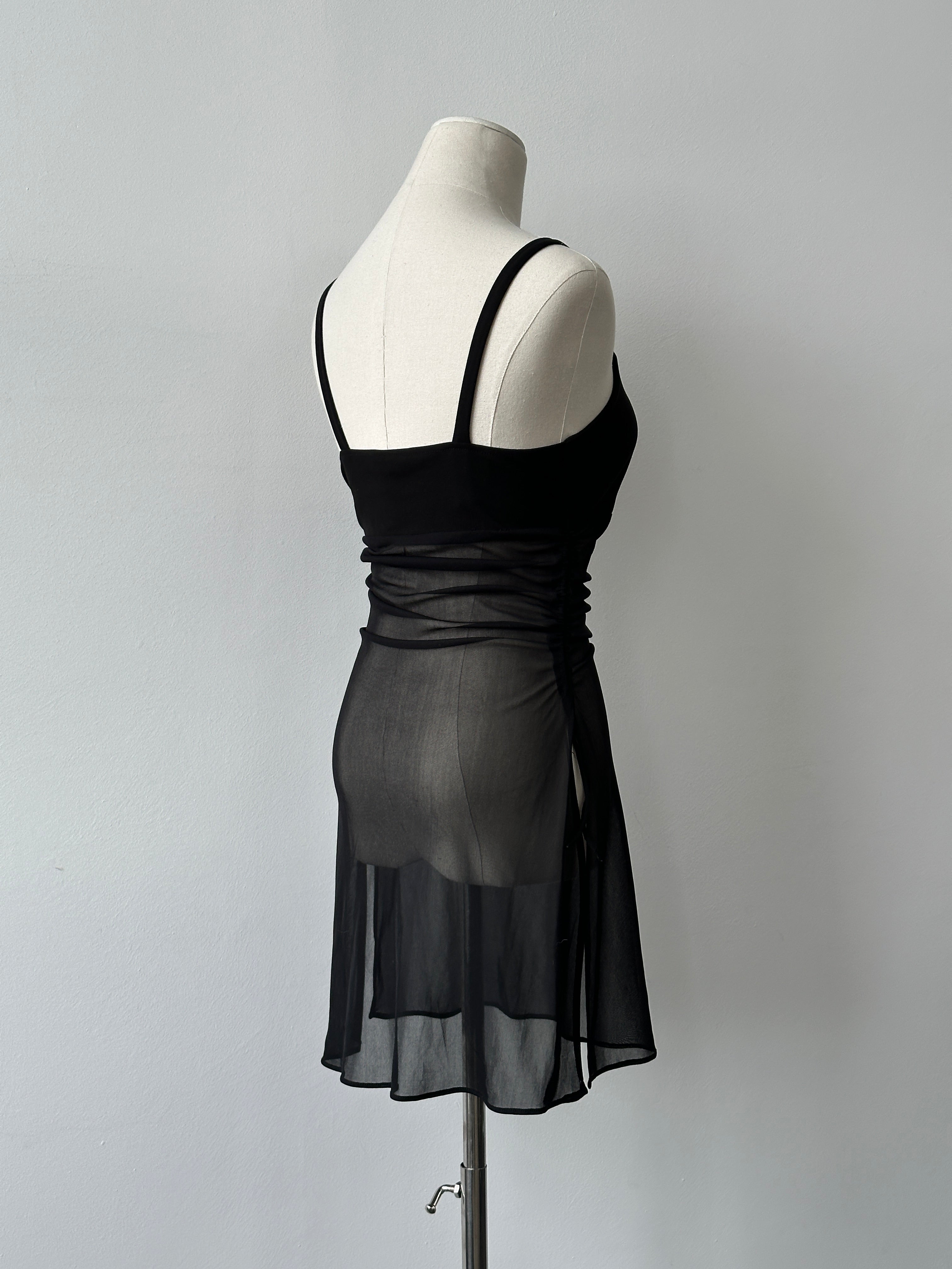 French vintage 1990s sheer sleeveless top with delicate fabric and classic design, featuring a fitted silhouette and subtle detailing.