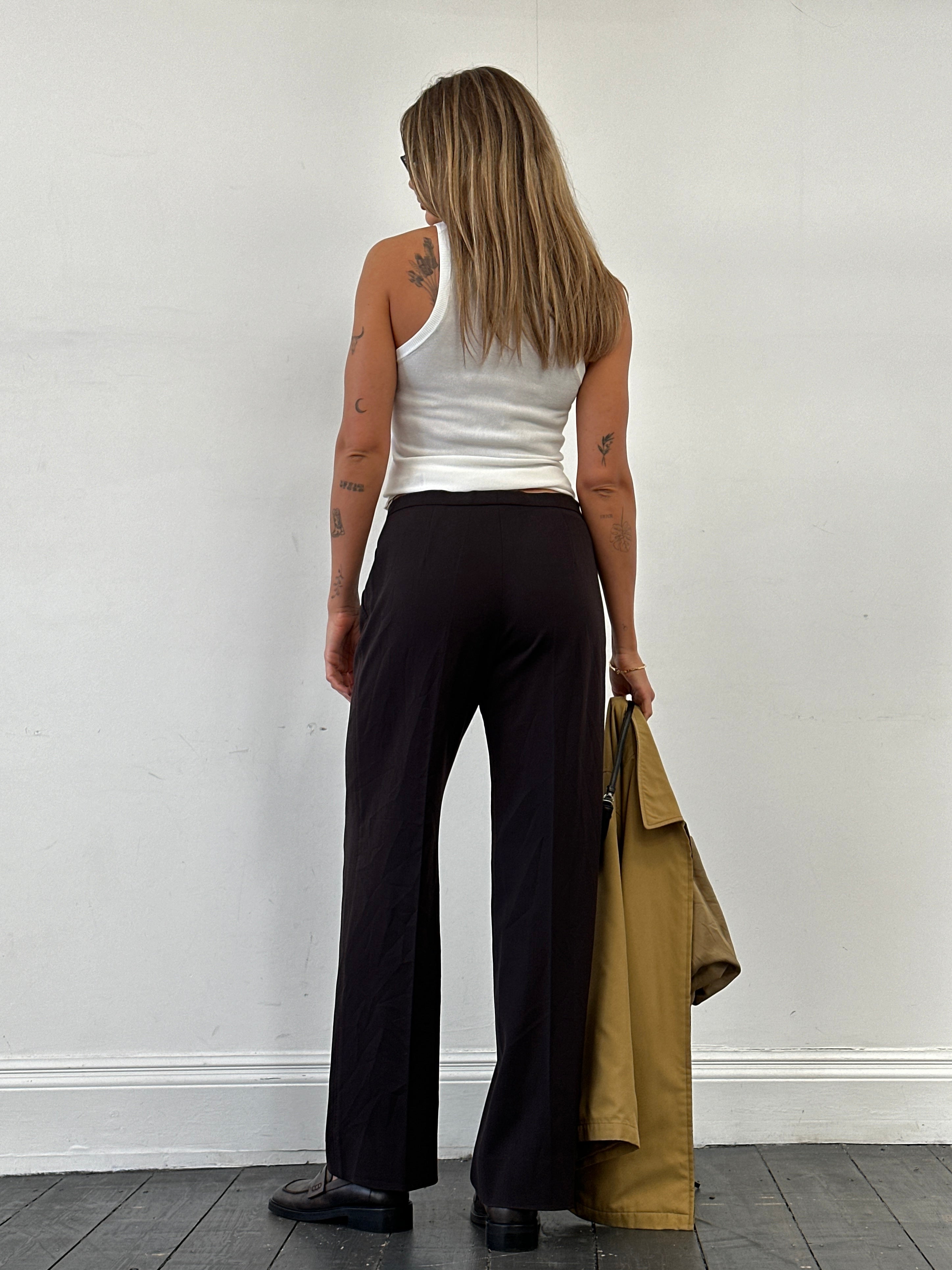 Max Mara minimal wool mid-waist tailored trousers in neutral fabric, displayed on a hanger with a clean background.