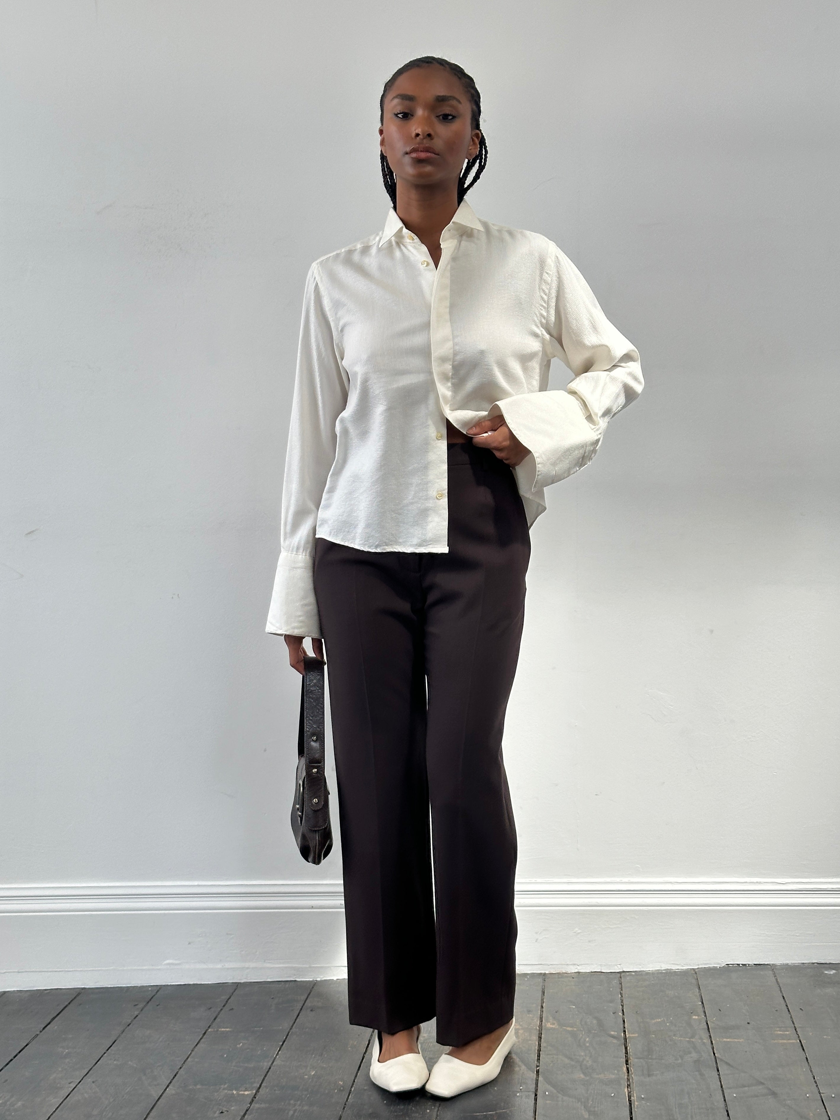 Max Mara high-waisted wool tailored trousers with straight-leg fit, shown in a neutral color on a hanger.