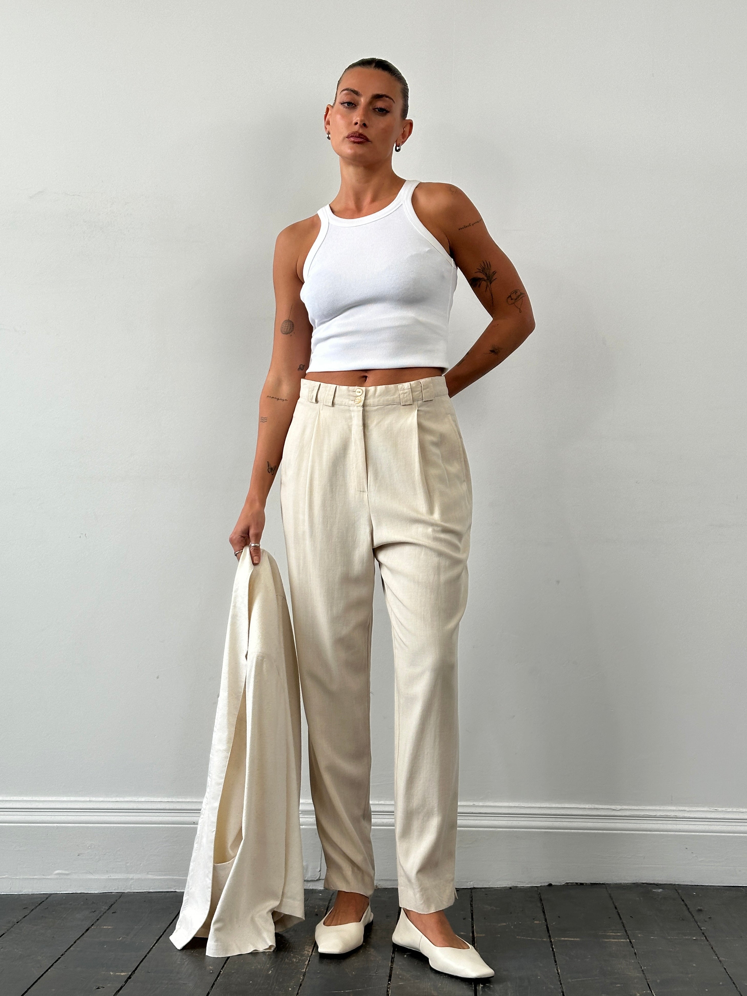 Vintage high waisted pleated tailored trousers in W28, showcasing the classic design and crisp fabric details.