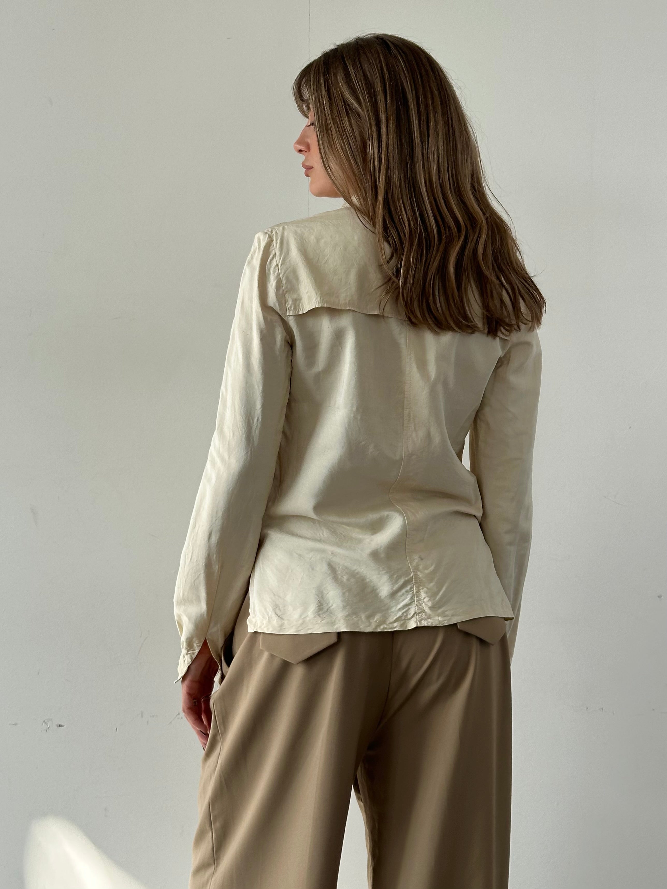 Vintage silk button-up shirt in size small, featuring a classic collar and elegant fabric with a vintage-inspired design.