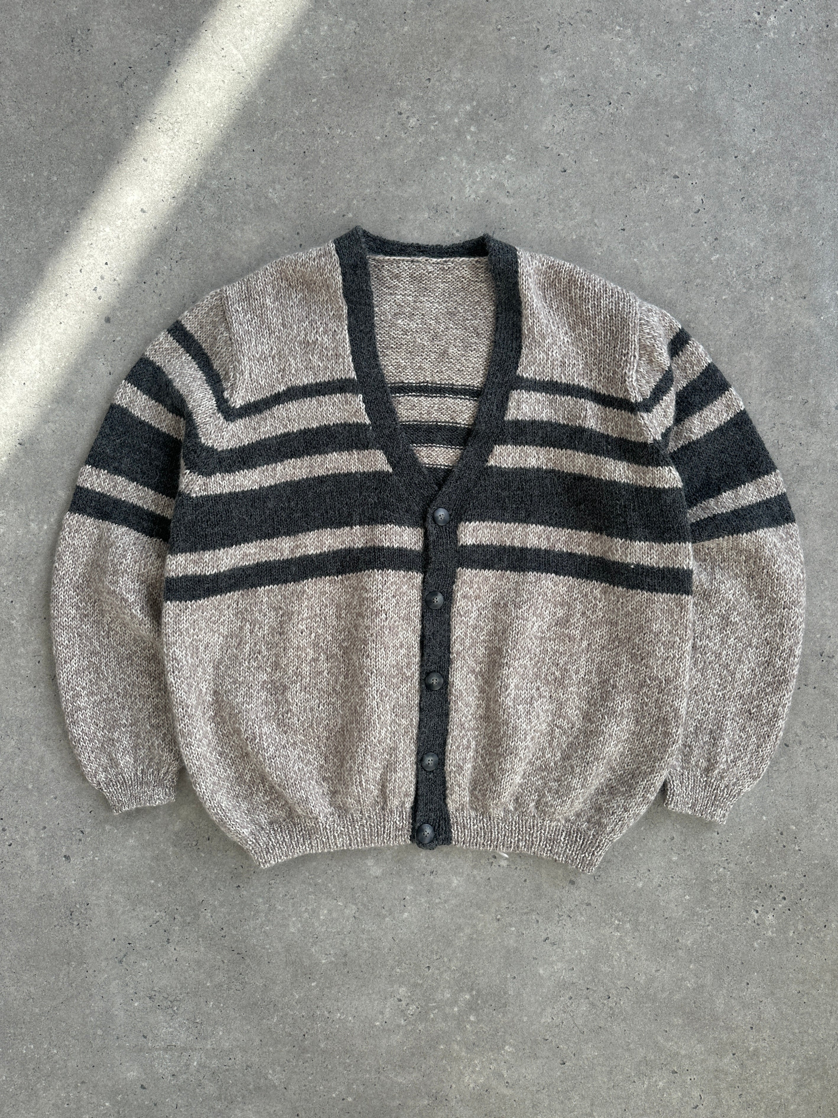 Vintage 1990s pure wool knitted stripe cardigan in size large/extra large, featuring colorful horizontal stripes and a cozy fit.