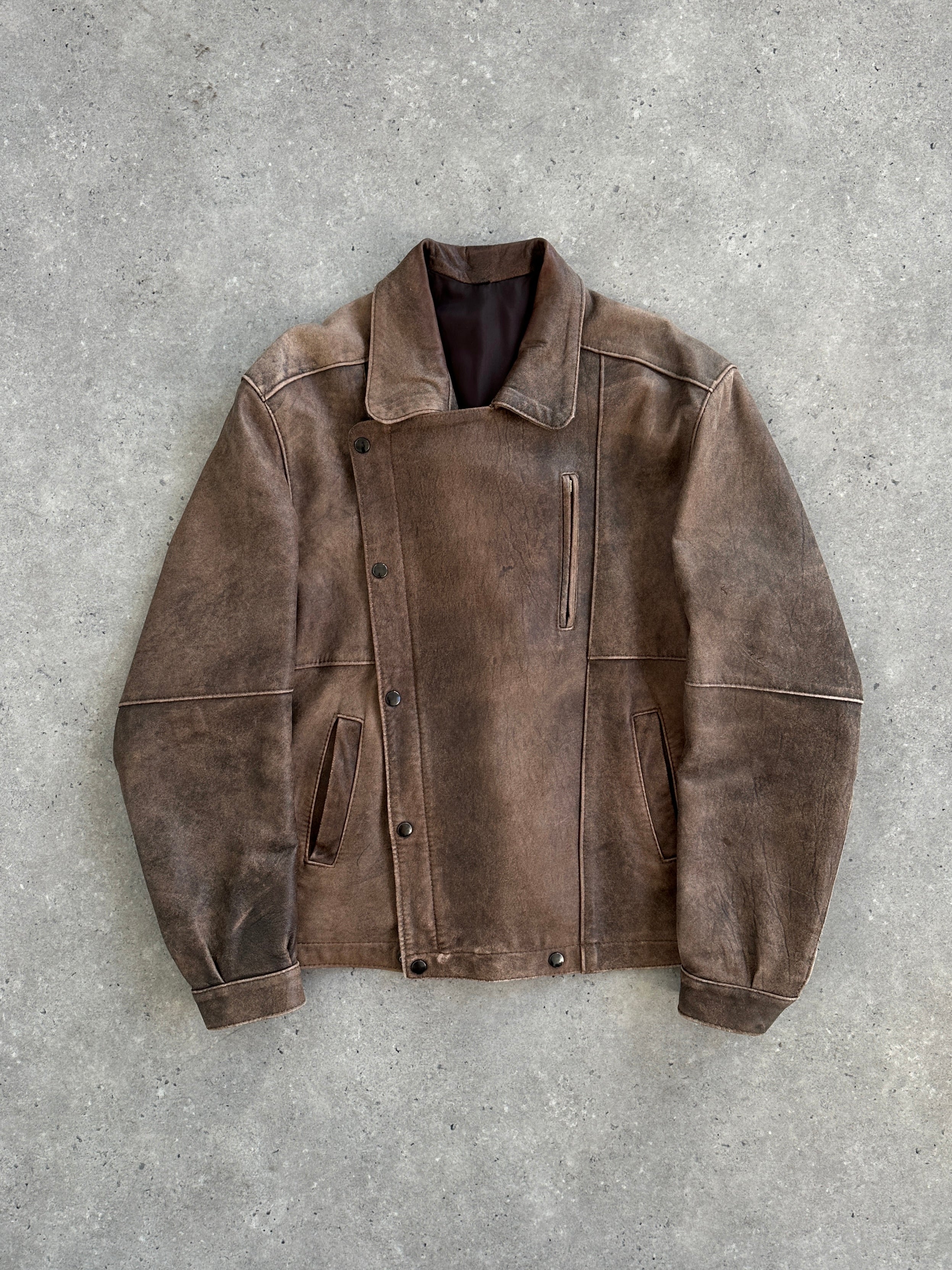 Vintage British vintage aged leather biker jacket in size M/L, featuring worn leather and classic biker style.
